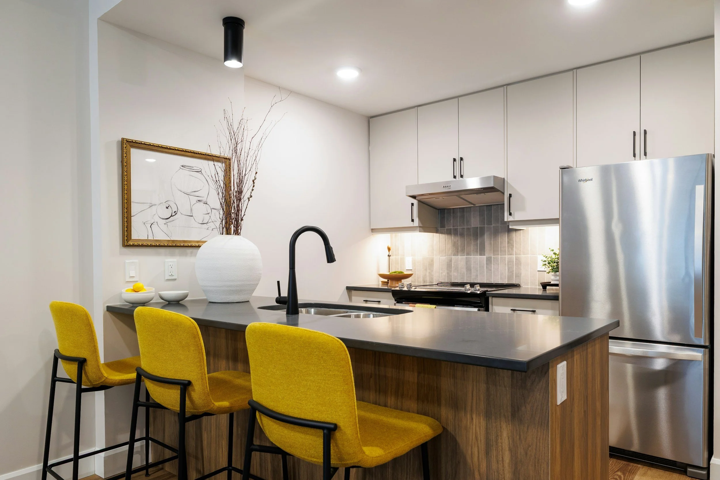 Kitchen styled with botanical branches in a vase, adding natural structure and sculptural presence to the space.