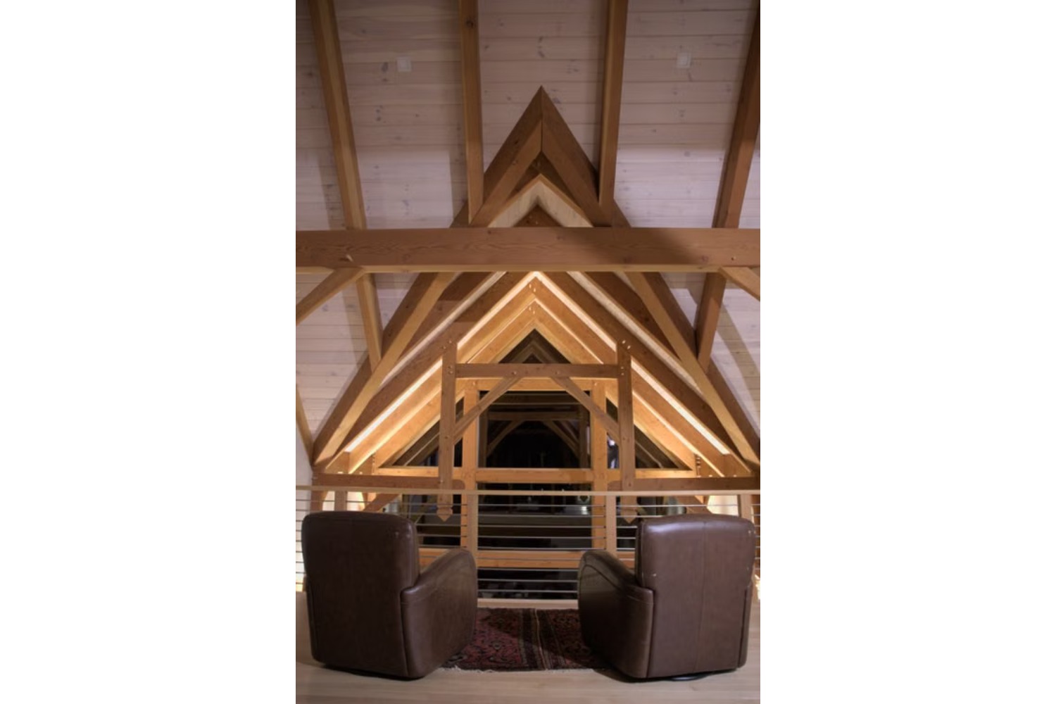 Exposed wood beams and timber framing create architectural interest in a vaulted ceiling.