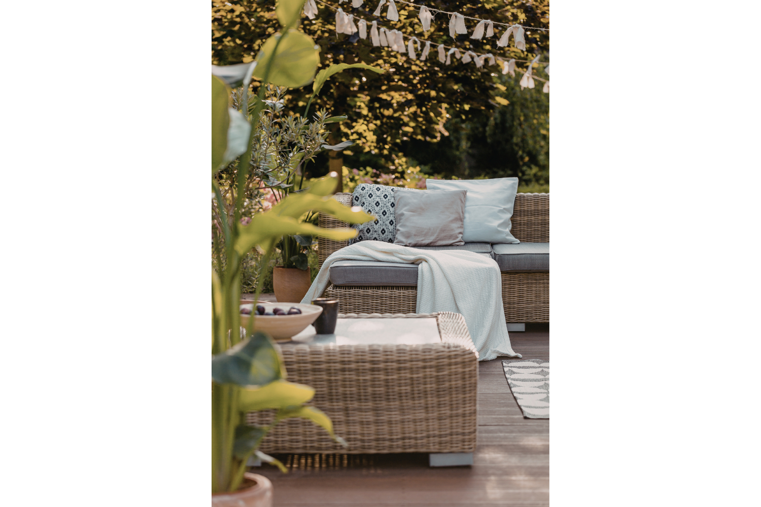 Layered outdoor seating with pillows, textiles, and lanterns