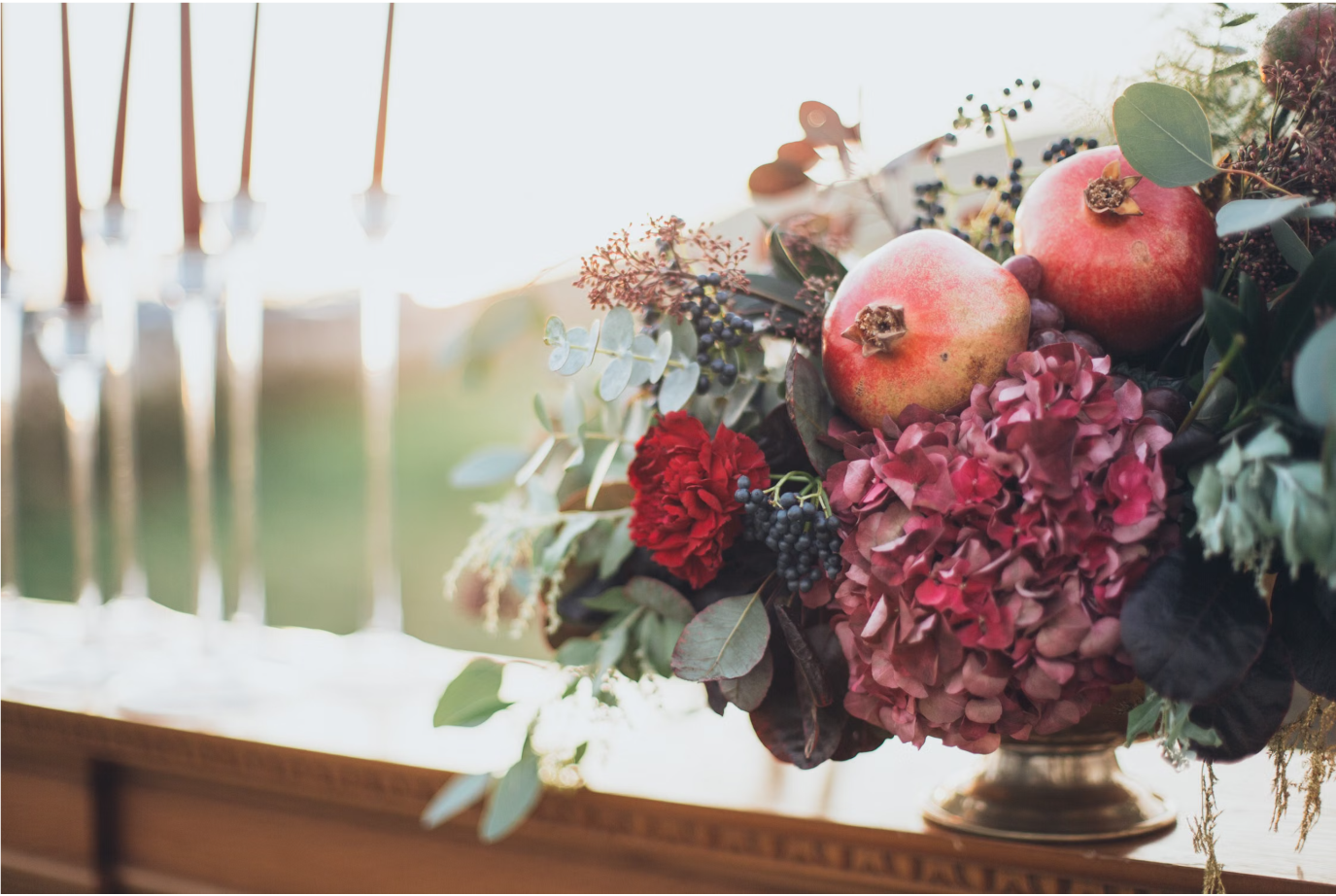 Fall 2026 color inspiration featuring wine red florals, pomegranates, earthy greens, and warm natural tones