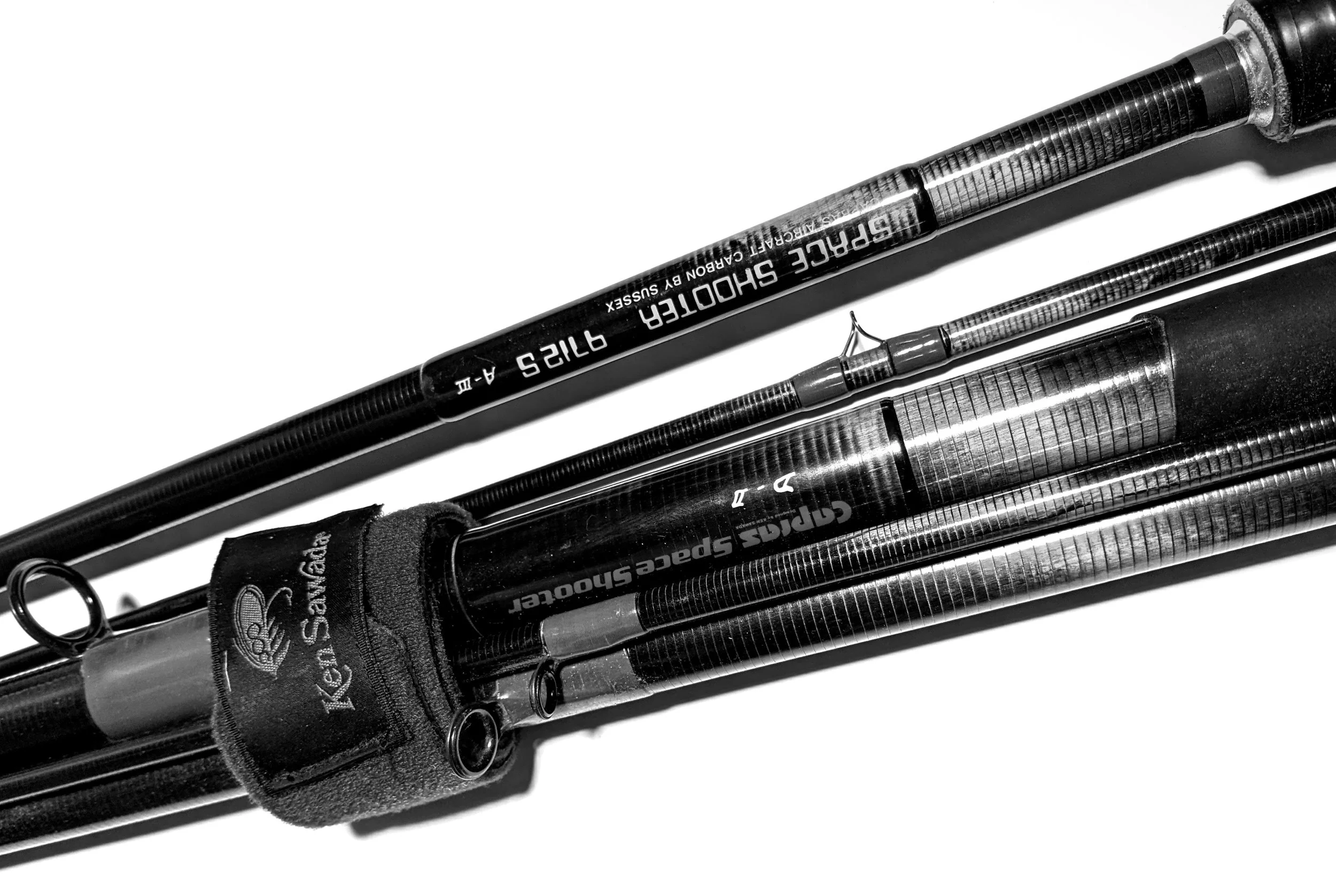A set of fishing rods arranged parallel to each other on a white background.