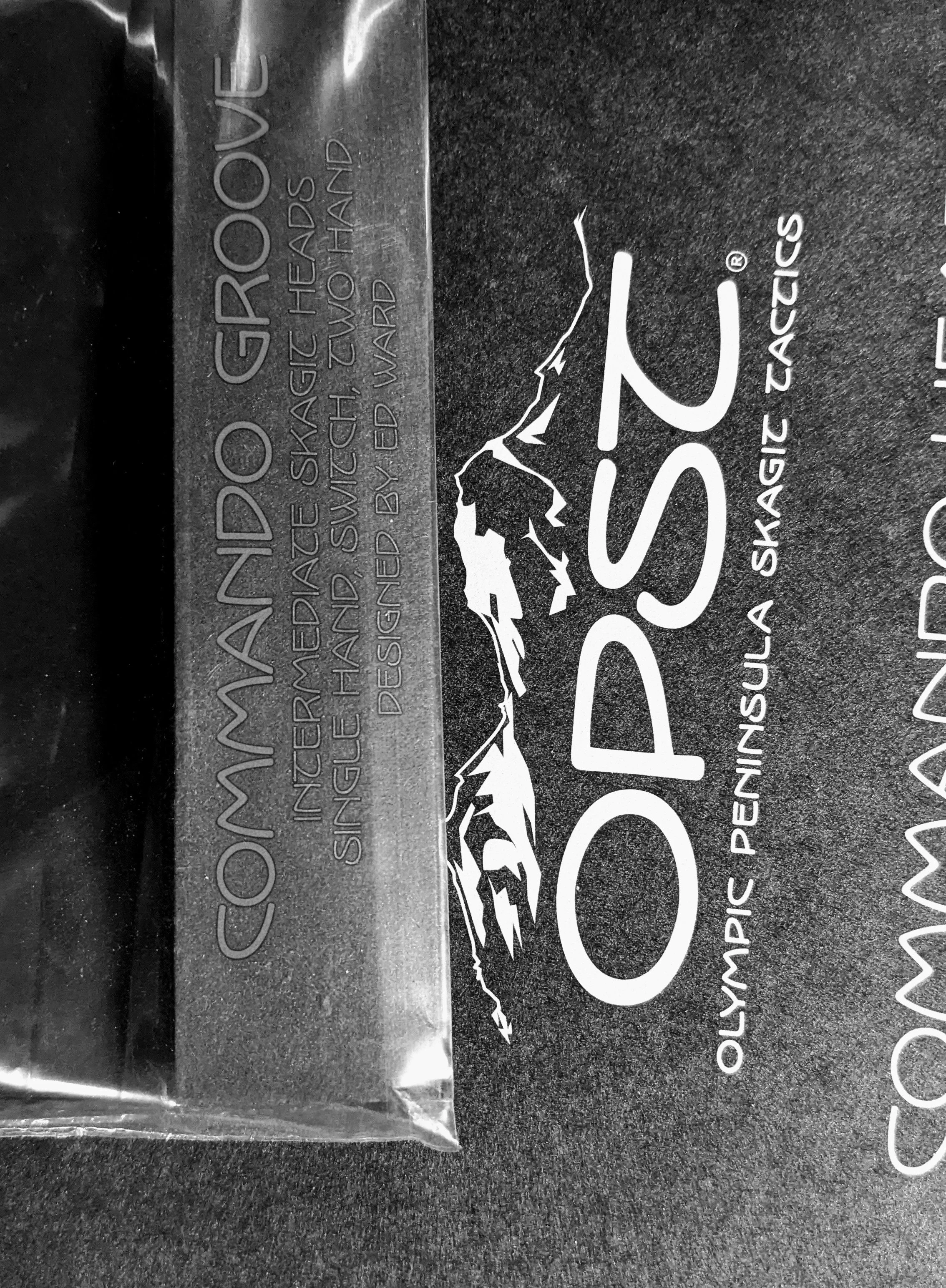 Close-up of a black label with white and gray mountain graphics and text, indicating the product is waterproof, designed for mountain biking, with additional safety warnings.
