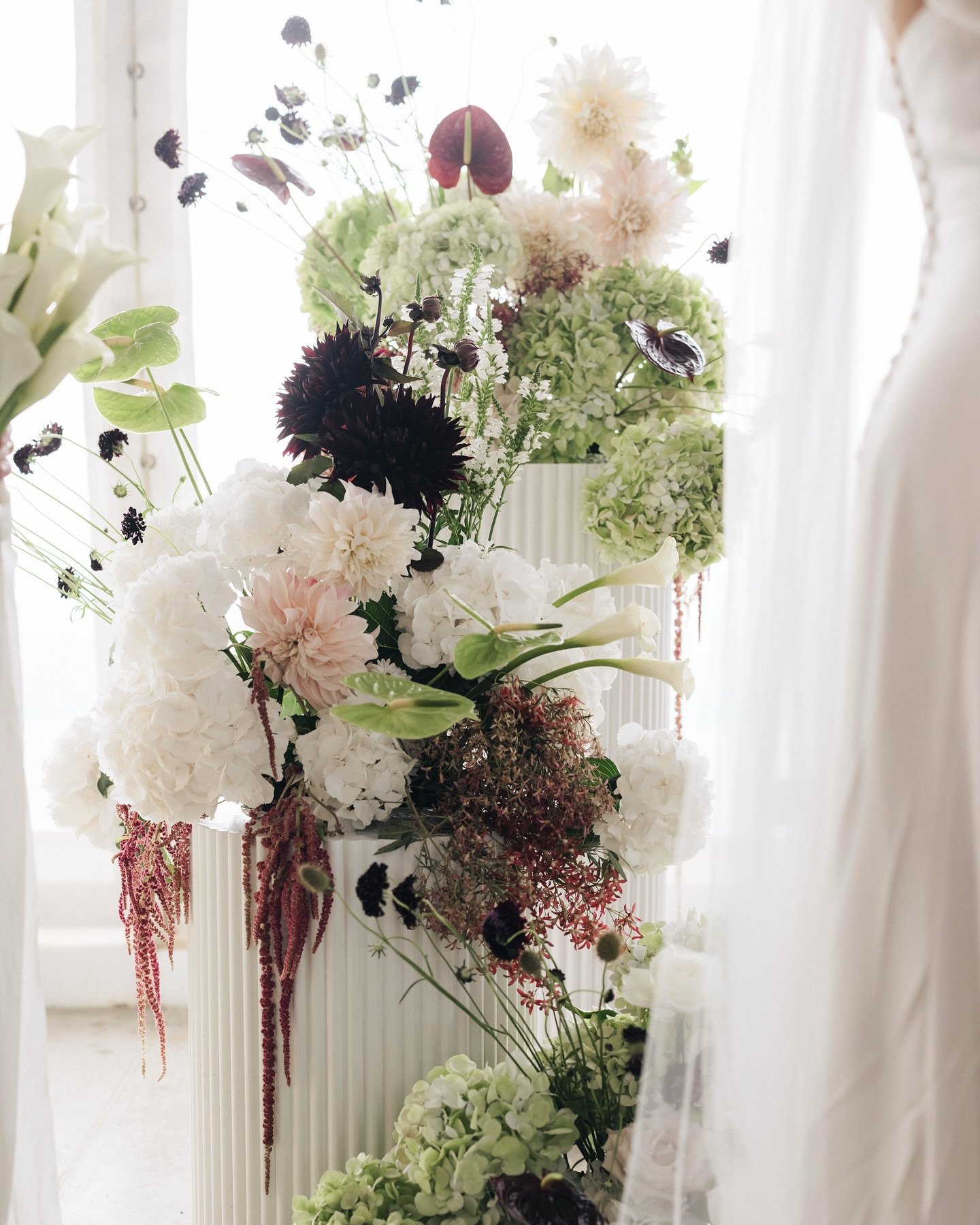 Chloe and Louis&rsquo; day was a celebration of moody hues and rich textures - deep cherry reds, soft matcha greens, and layers of natural beauty. Hydrangeas, roses, calla&rsquo;s, dahlias, scabiosa and amaranthus came together to create lush, organi