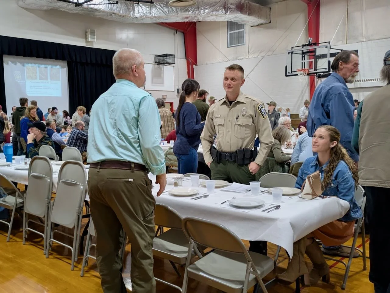 Kyle Robinson, PA Fish and Boat Commission Conservation Officer, talking with chapter member Gary Parzanese
