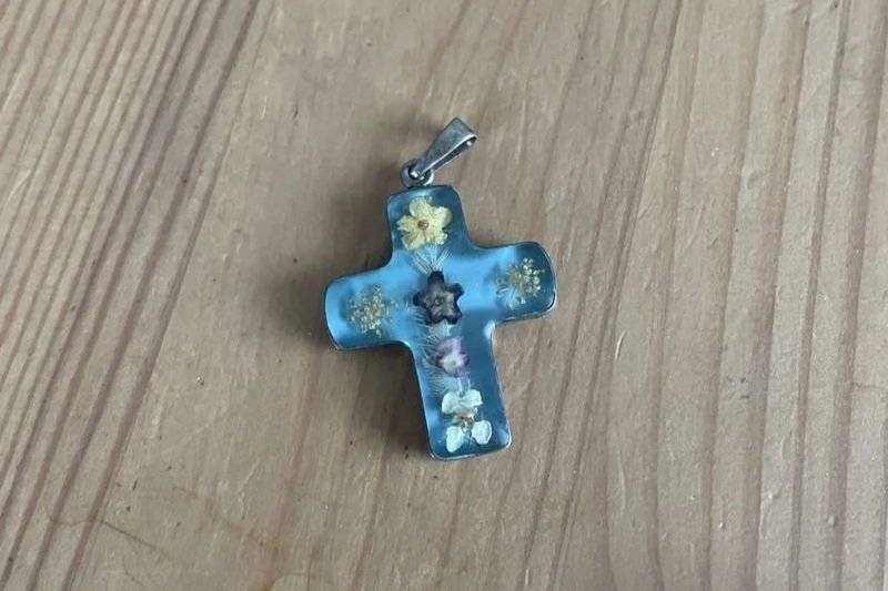 Small blue cross with flowers embedded