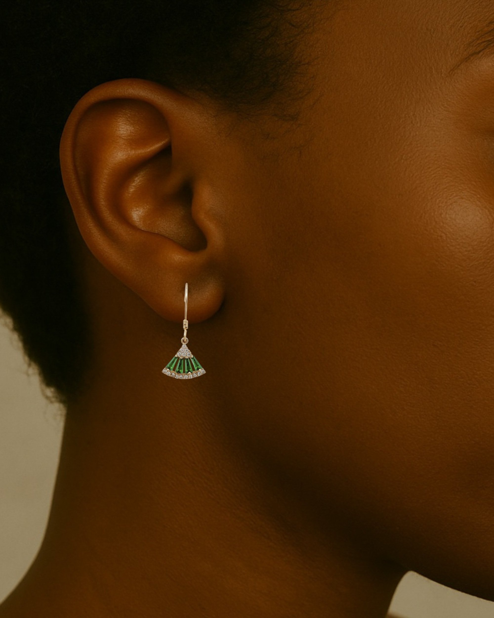 The Frida earrings are elegant and delicate. Green and white moissanite stones make up the fan motif. These beautiful earrings are crafted in 18 karat yellow gold vermeil