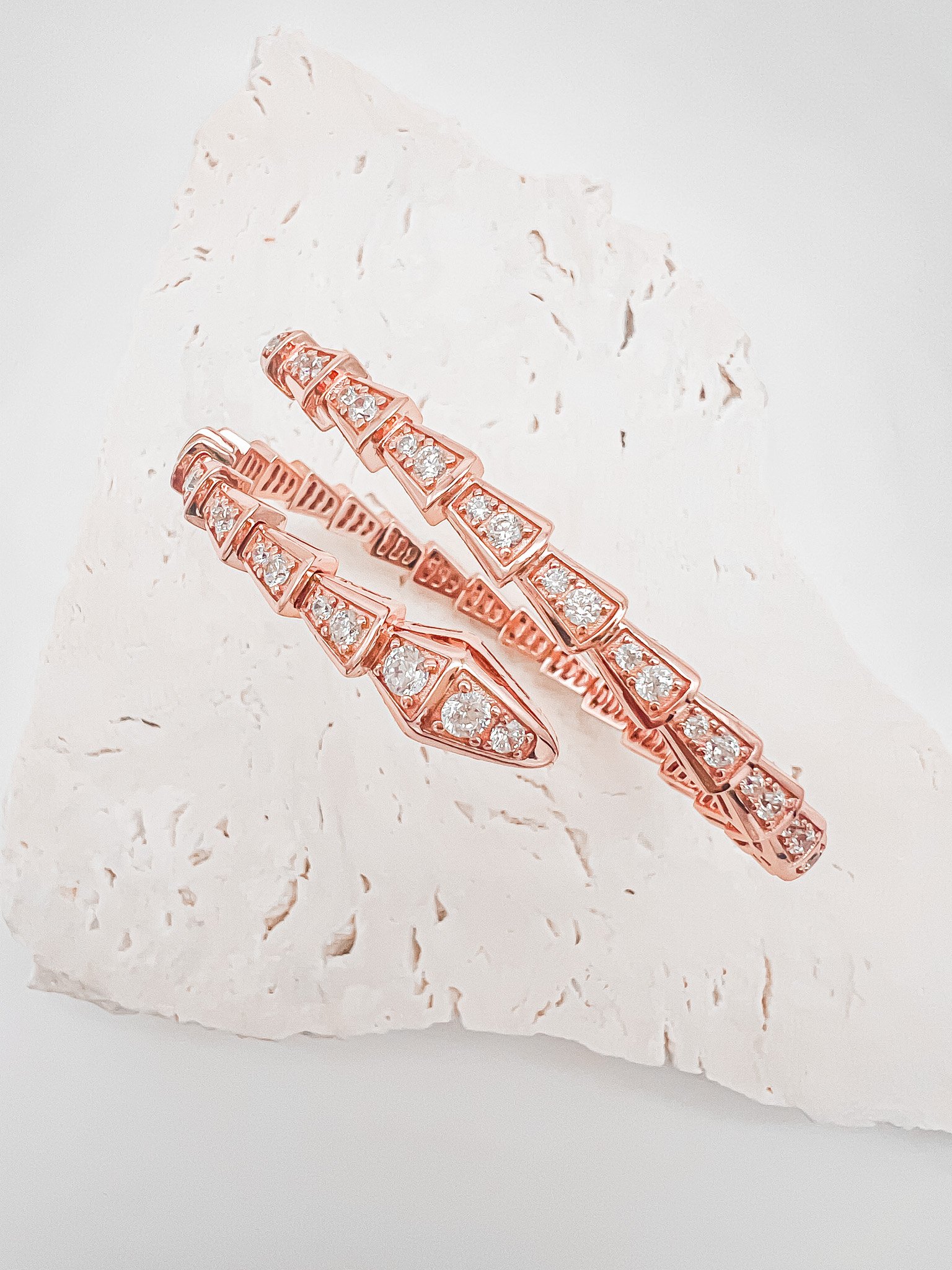 The serpent inspired design is bold and unique, handcrafted in sterling silver and plated with 18 karat rose gold vermeil, with stunning moissanite stones throughout.