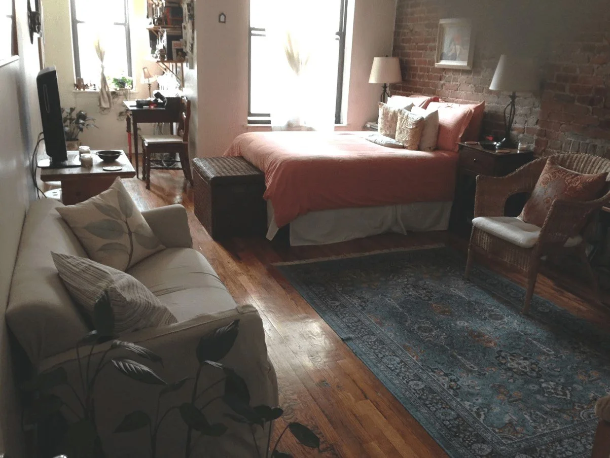 View of living area, bedroom, and home office.