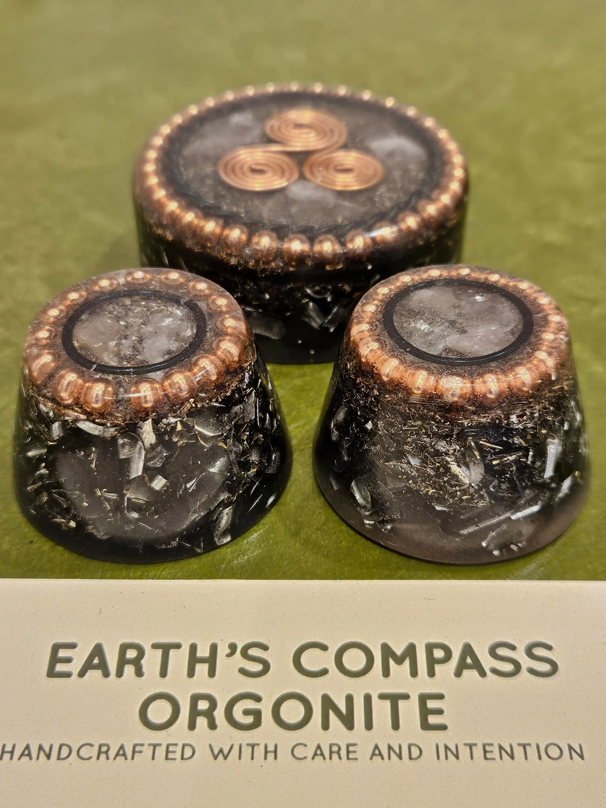 Earth’s Compass – Table / Pocket Orgonite
Table Orgonite Price: £35
Pocket Orgonite Price: £25
Element: Earth

Crystals & Metals
• Quartz Crystal,  Rose Quartz 
• Black Tourmaline, Hematite
• Shungite –  
• Metal Swarf 
• Copper Triskelion 

Purpose: