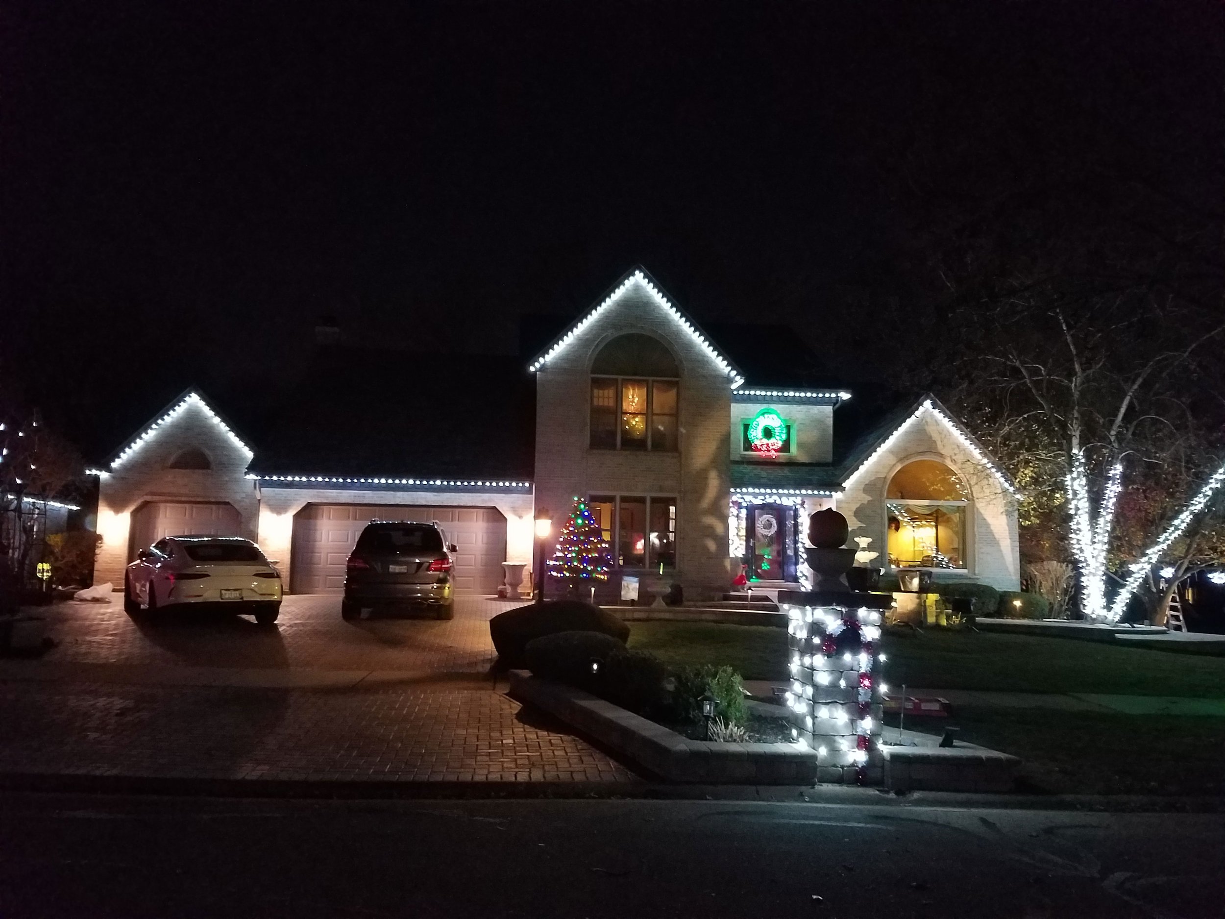 J&V clients: Exterior of a Chicago residence decorated with exterior Christmas lights. Includes Rooftop, front door, windows and trees