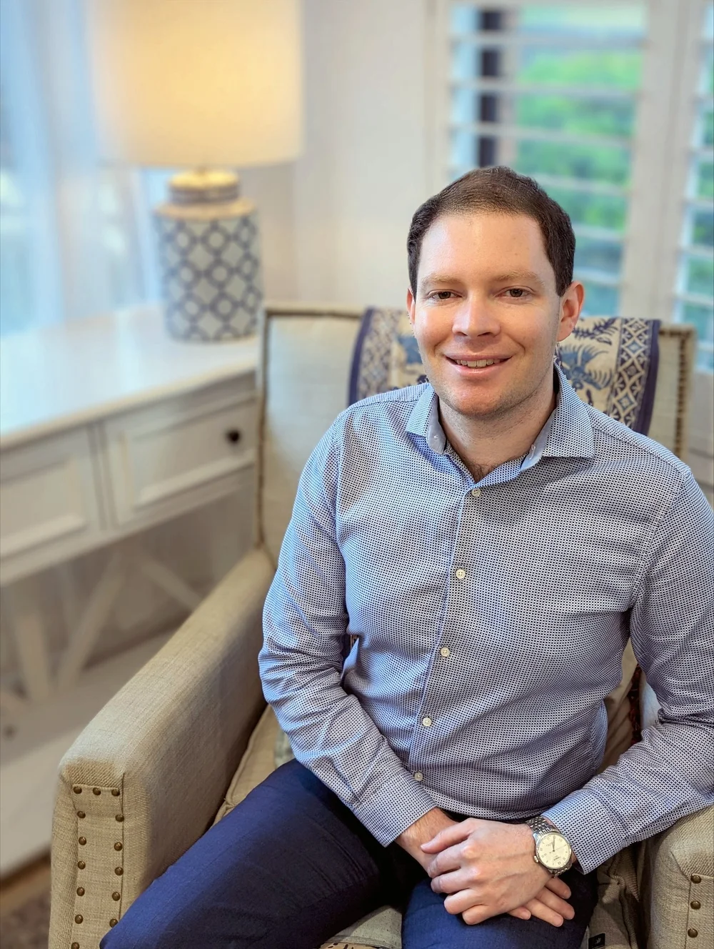 Luke Wright, Clinical Psychologist, seated in a bright consulting room
