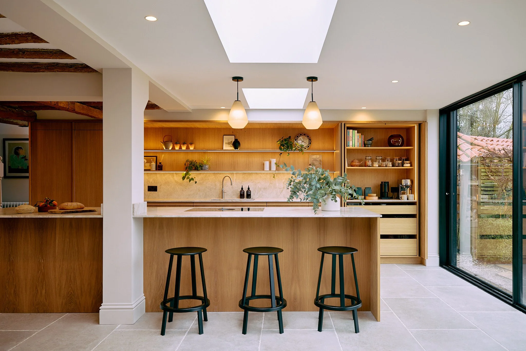 Bespoke oak kitchen with natural materials and stone worktops in Nottinghamshire home by Boyes Design