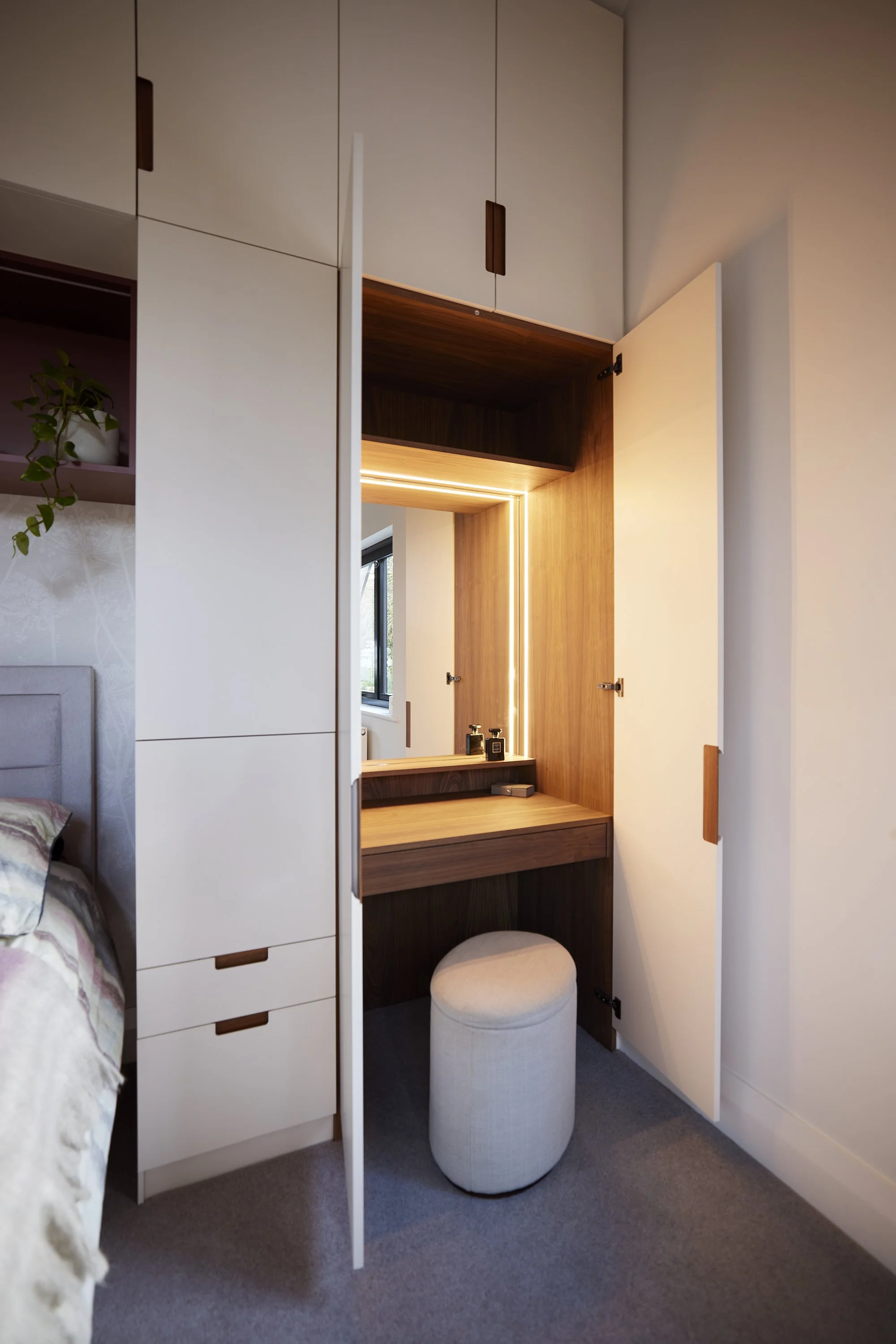 Hidden dressing table integrated into bespoke bedroom cabinetry
