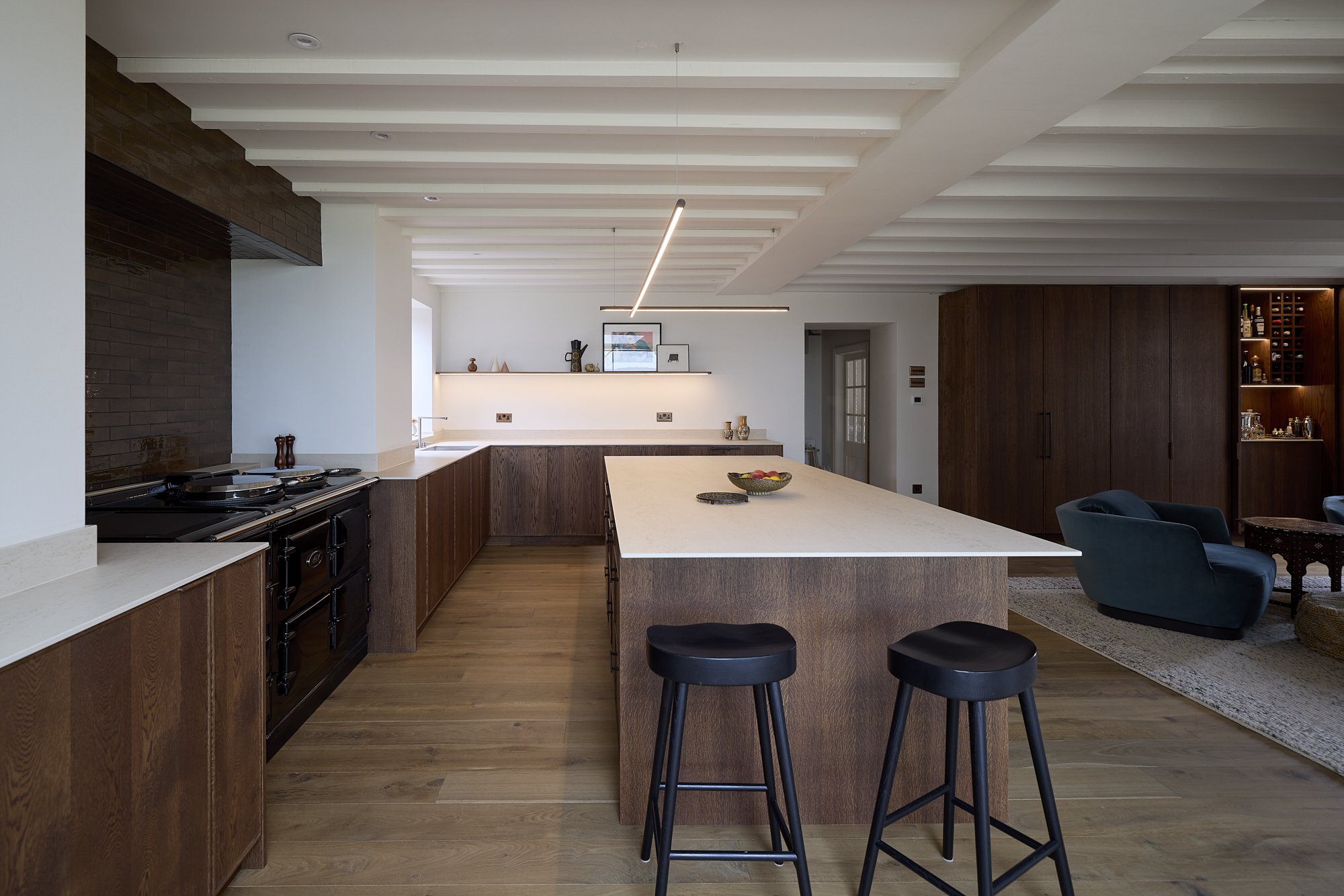 Natural stone worktop and oak kitchen cabinetry in bespoke kitchen design