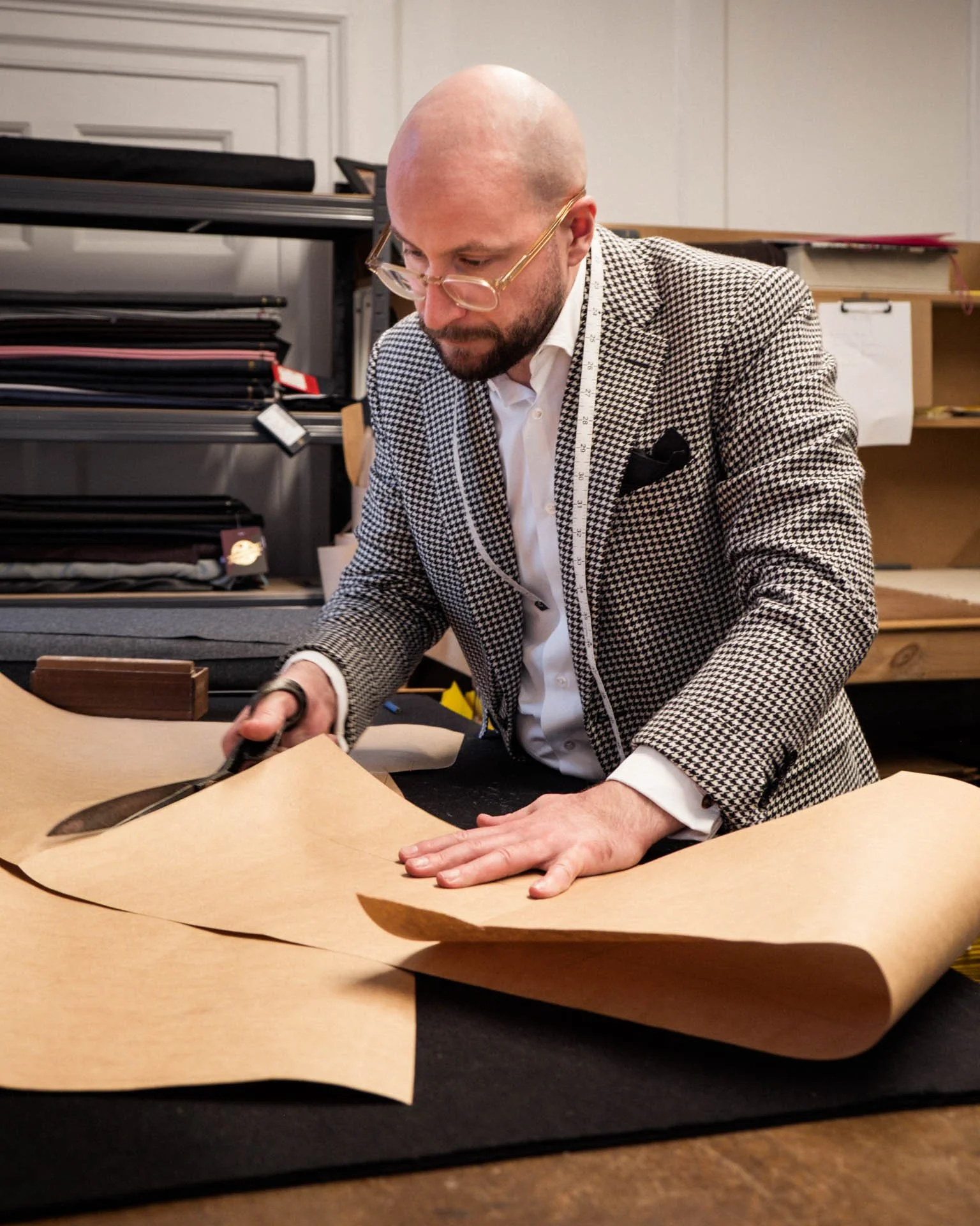 Joseph Butler, Head Cutter at Edward Sexton, working in the cut room.