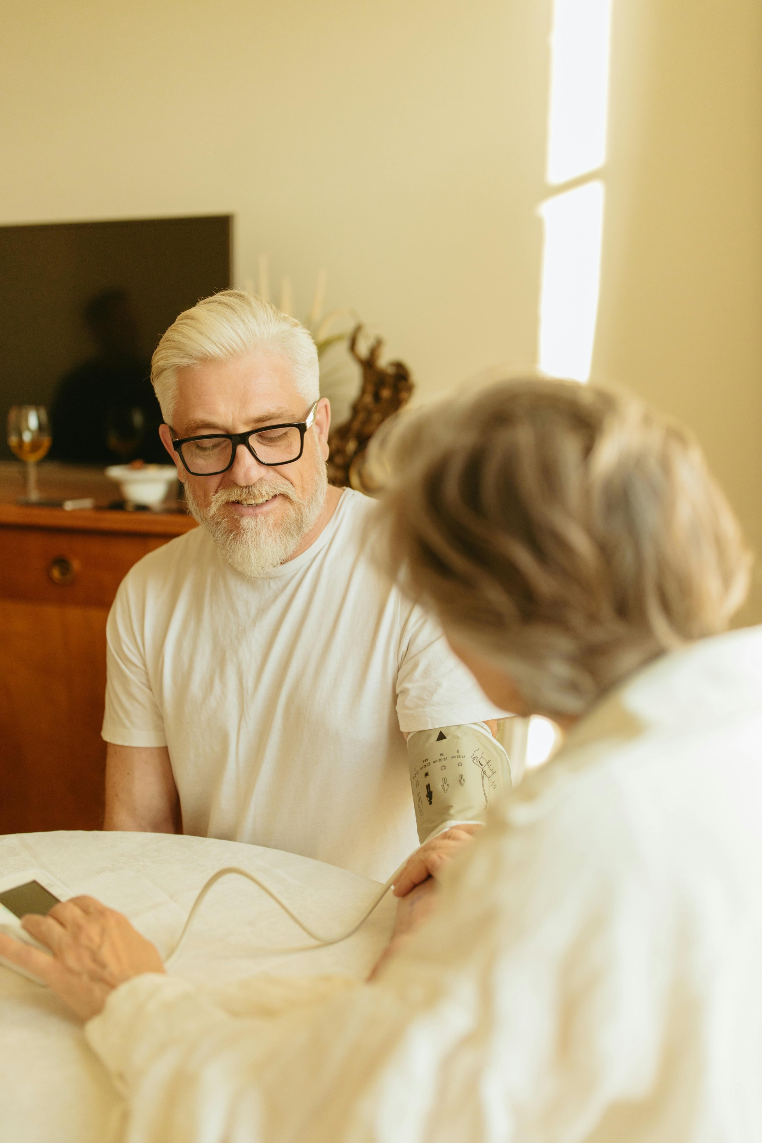 Person taking a blood pressure measurement from a home monitor cuff.t