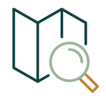 A folded map with a magnifying glass placed over it.