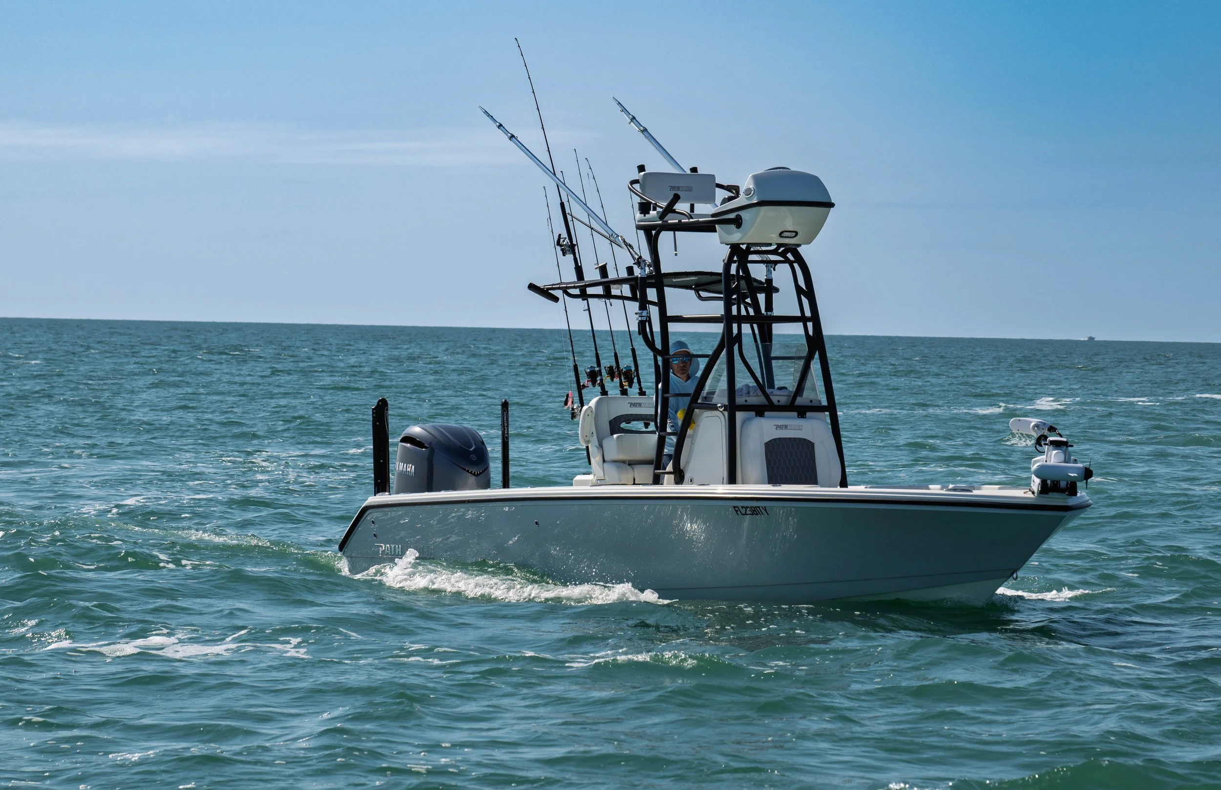 A boat with fishing rods on the water.