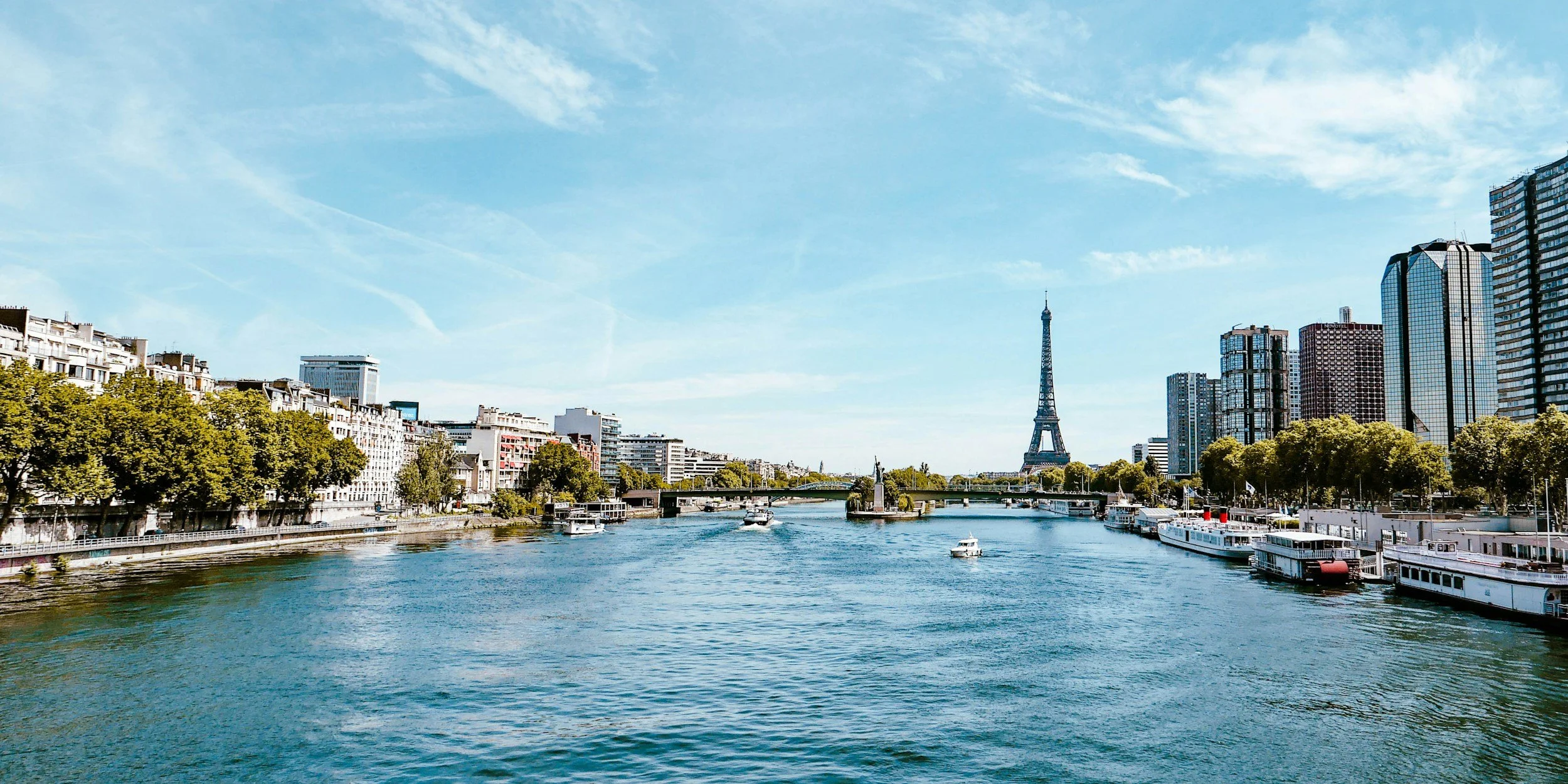 View from the Seine River with the Eiffel Tower in the distance.