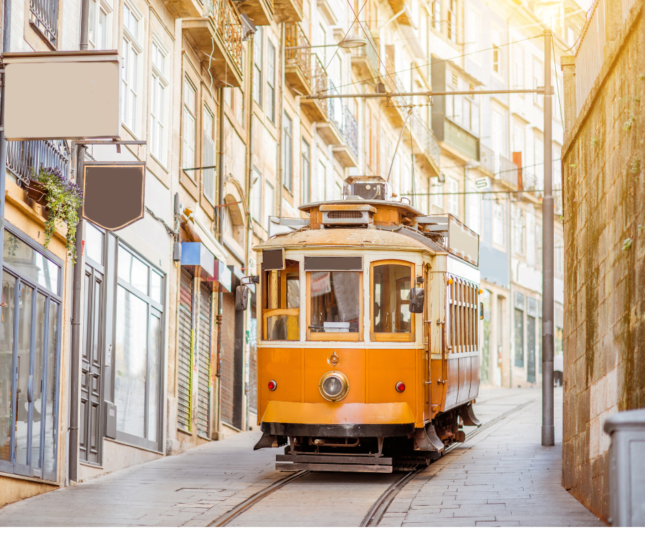 A yellow classic cable car in the streets of Lisbon, Portugal