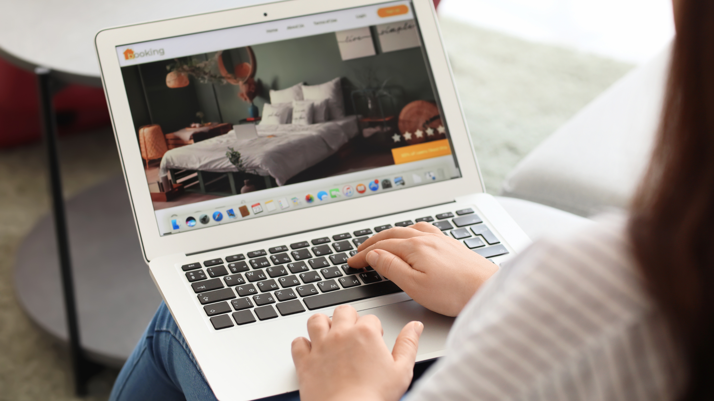 a person using a laptop to book a hotel online.