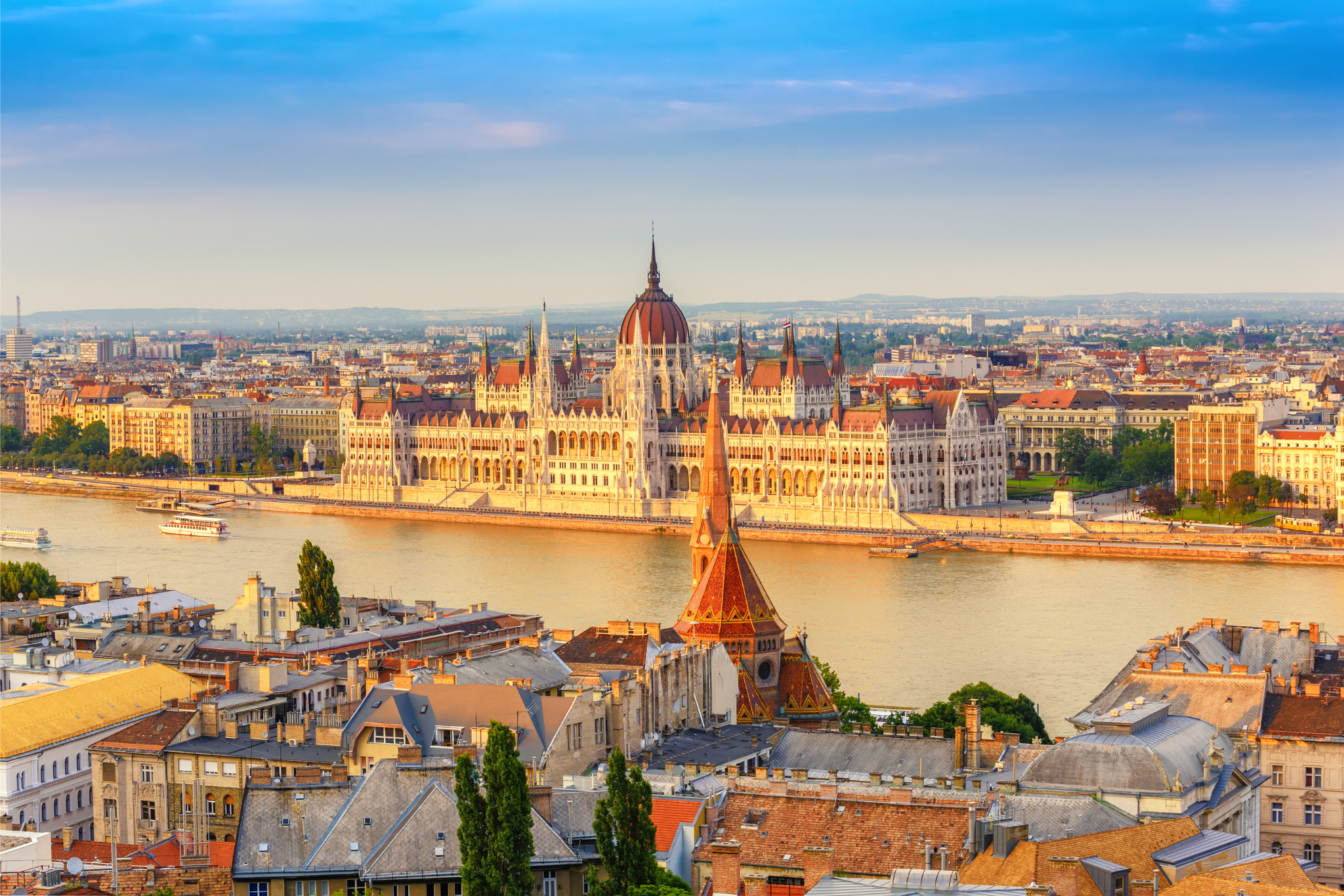 Budapest city skyline with parliament and danube river in view.