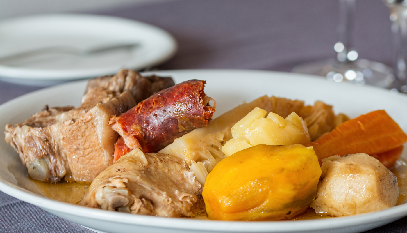portuguese stewed meats including, pork, sausage, potatoes, carrots, and cabbage