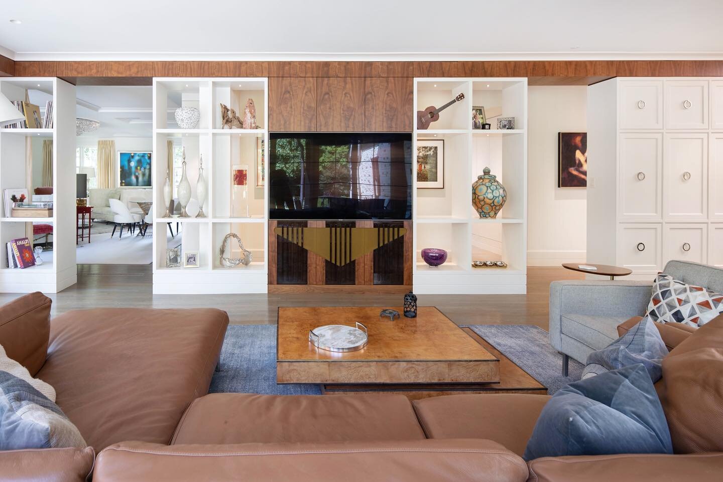 Art Display and TV Wall.  Retro Speaker Cover, Stained Walnut Inlays with Mirror Finish.  Many Details went into hiding the Steel House Supports and Access to all the TV / Stereo Controls.  Finished all Sides with Hidden Doors in the Hallway for Acce