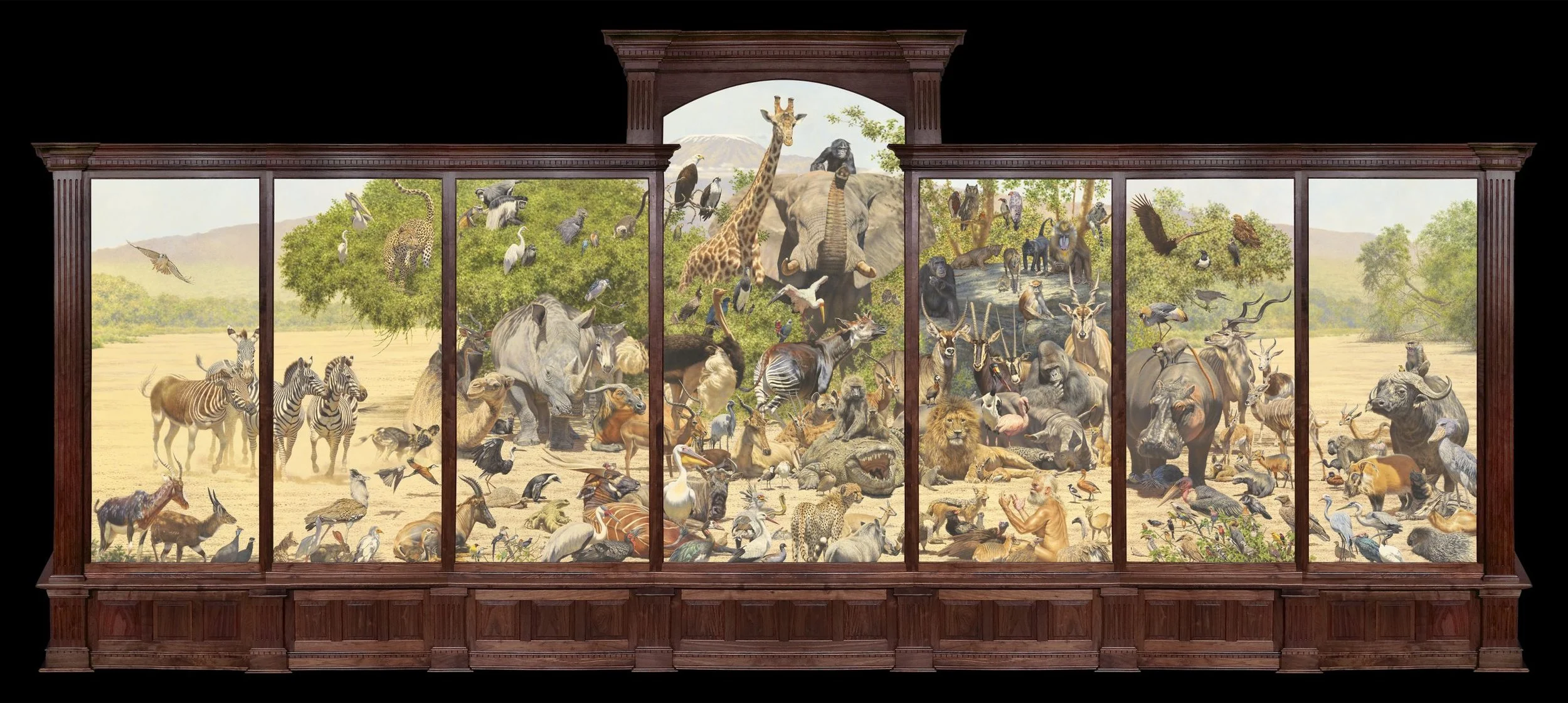 A mural showcasing a diverse array of African wildlife, including elephants, giraffes, zebras, lions, rhinoceroses, and various birds, set in a savannah landscape. The artwork is displayed within a dark wooden frame.