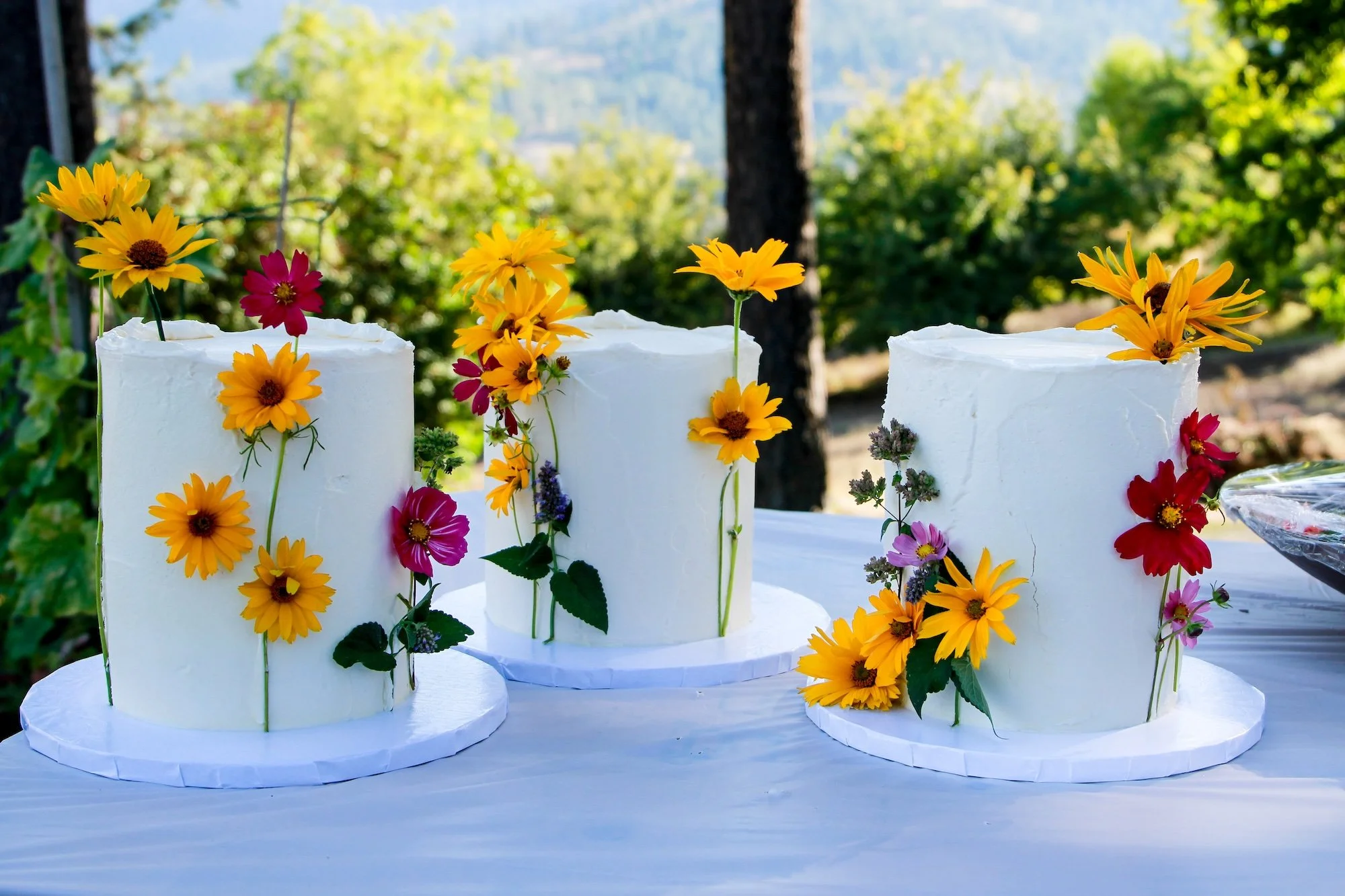 sunflower-wedding-cakes-on-outdoor-table.jpeg