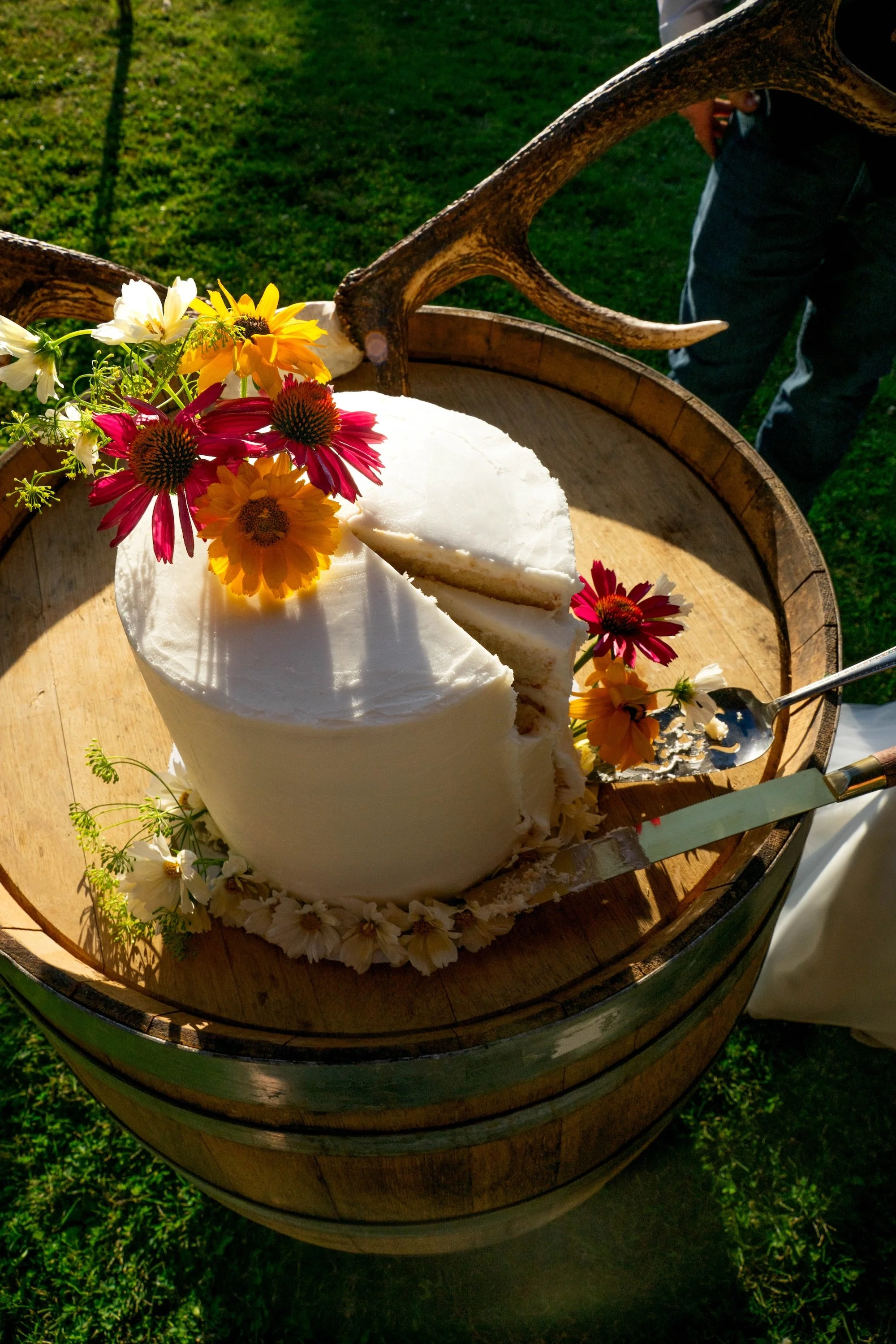 wedding-cake-with-florals-on-barrel.jpeg