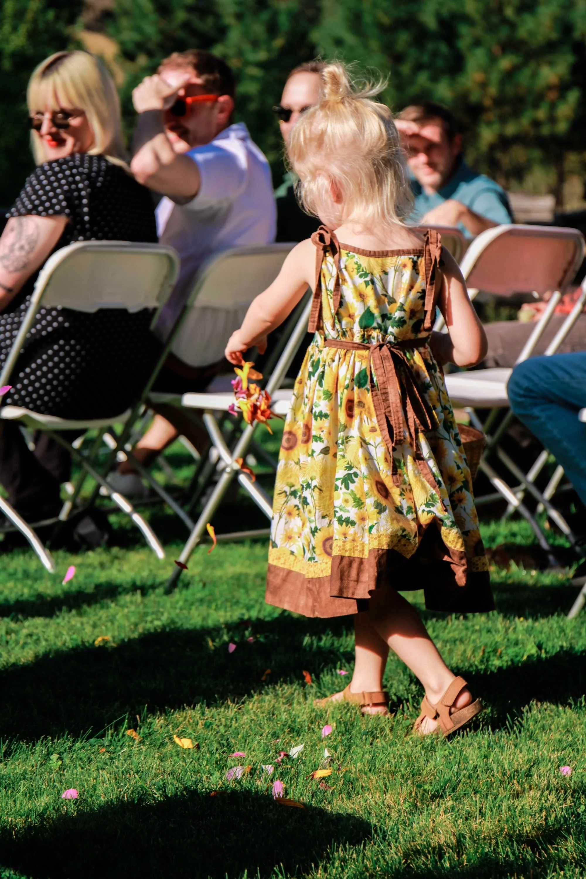 flower-girl-walking-outdoor-ceremony-aisle.jpeg