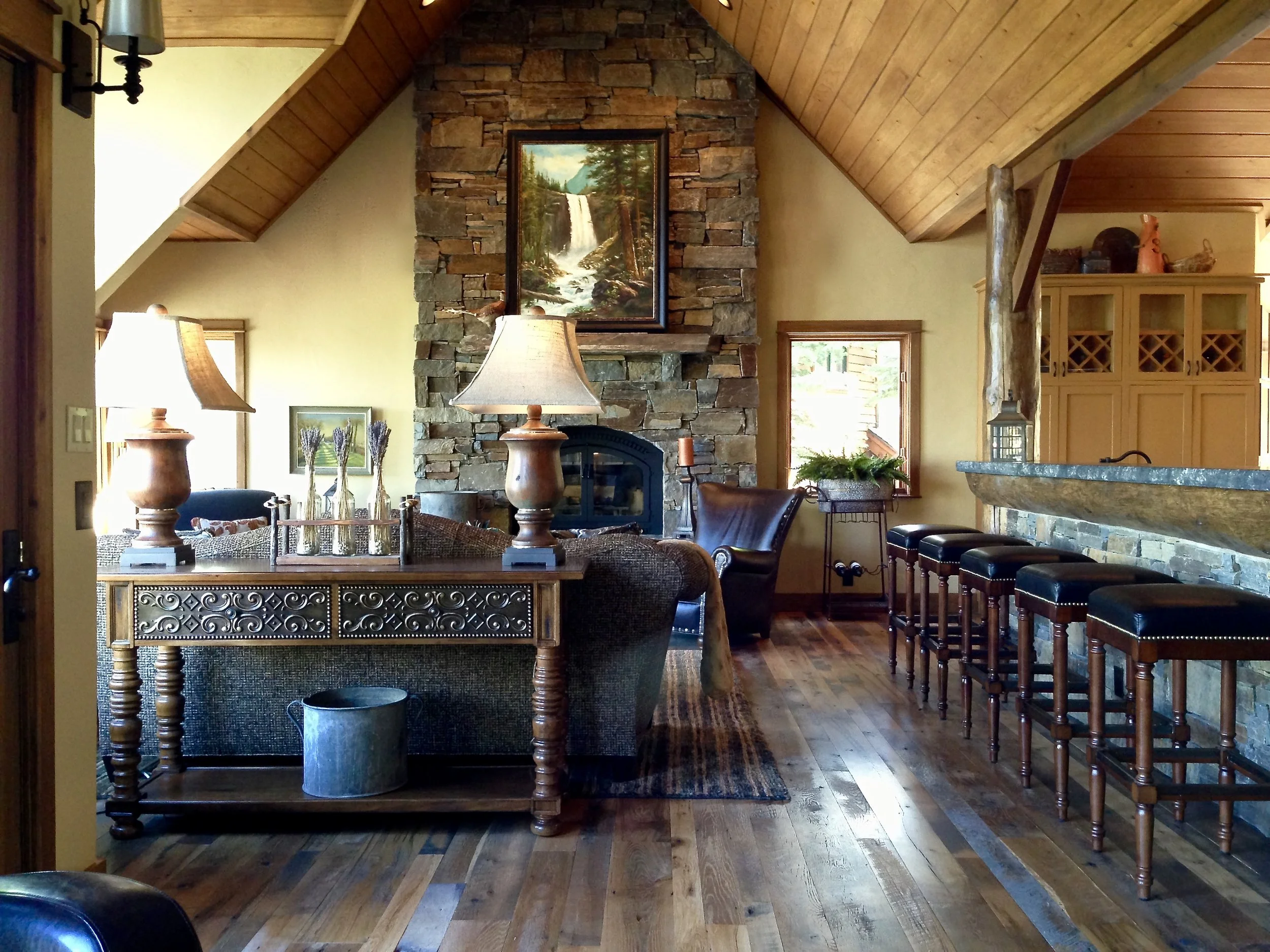 Great room with soaring ceiling and stone fireplace at Gray Wolf Haven