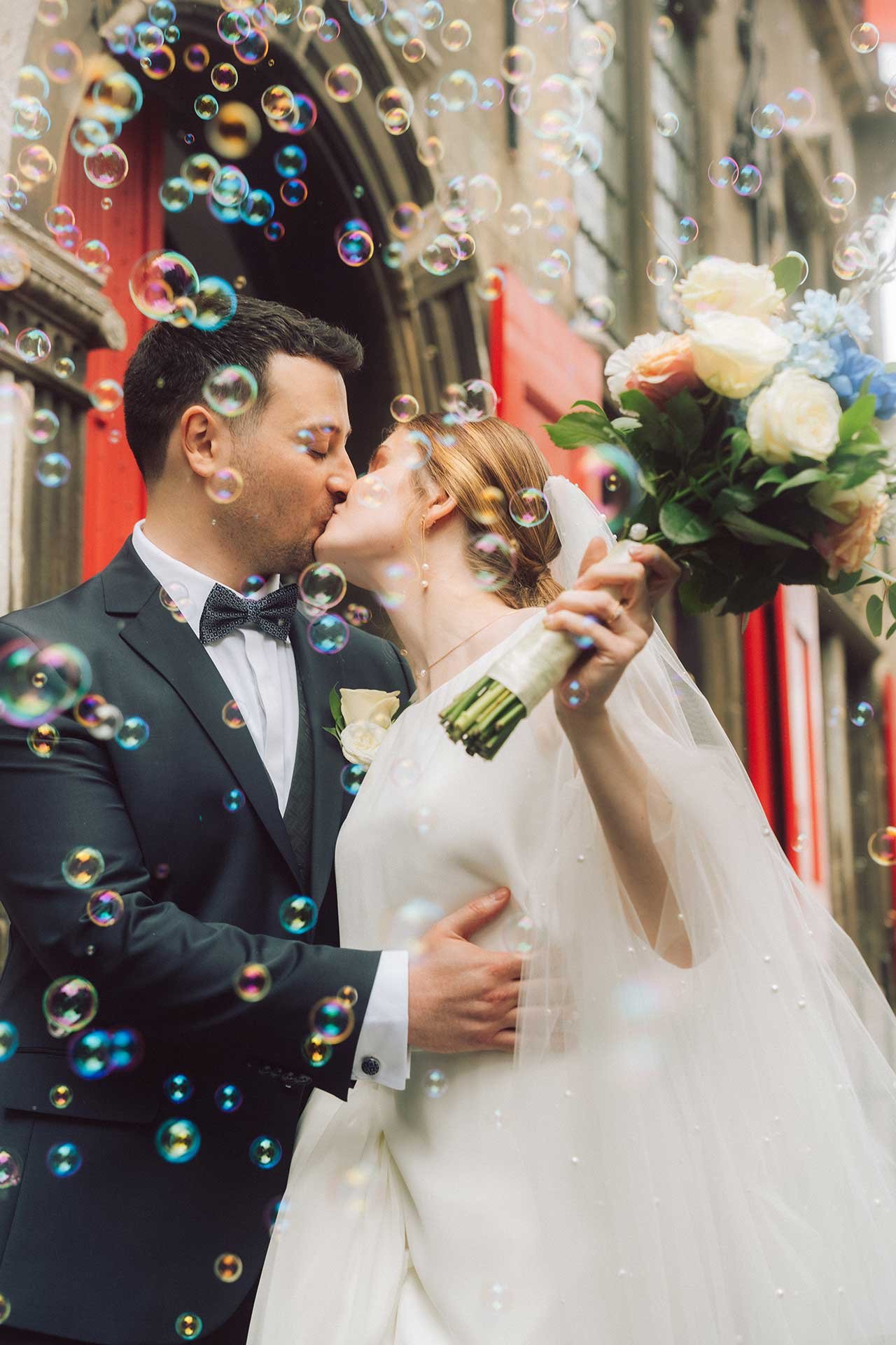 A tender kiss exchanged amidst a cascade of effervescent bubbles, celebrating love's joy. An image reflecting the vibrant spirit of Dutch wedding celebrations