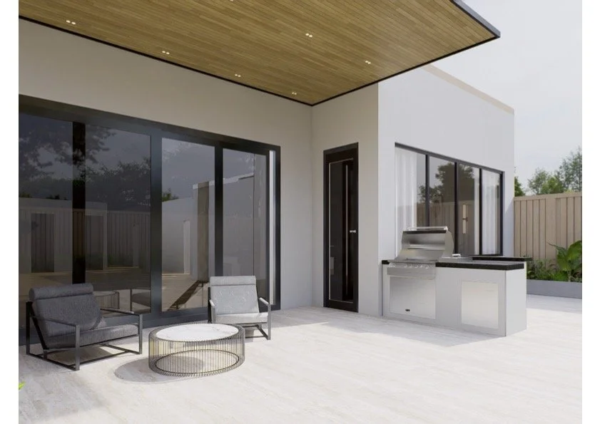 Modern backyard patio with outdoor seating and a built-in grill, adjacent to a house with large glass doors and a sliding window.
