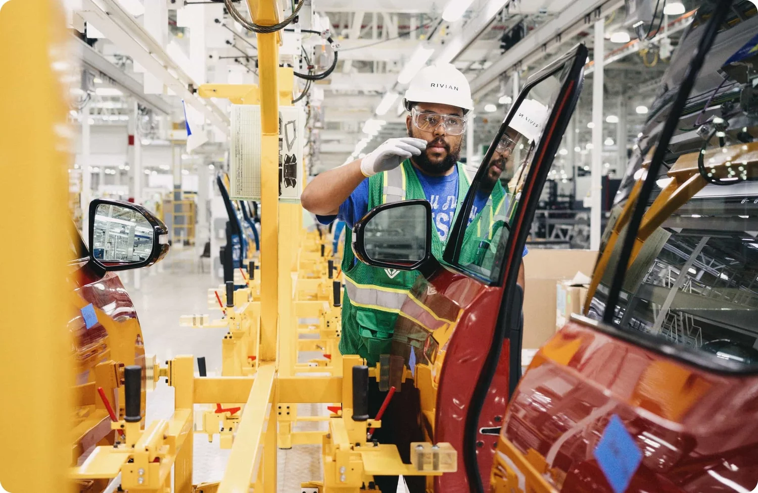 A Rivian team member at work on the production line