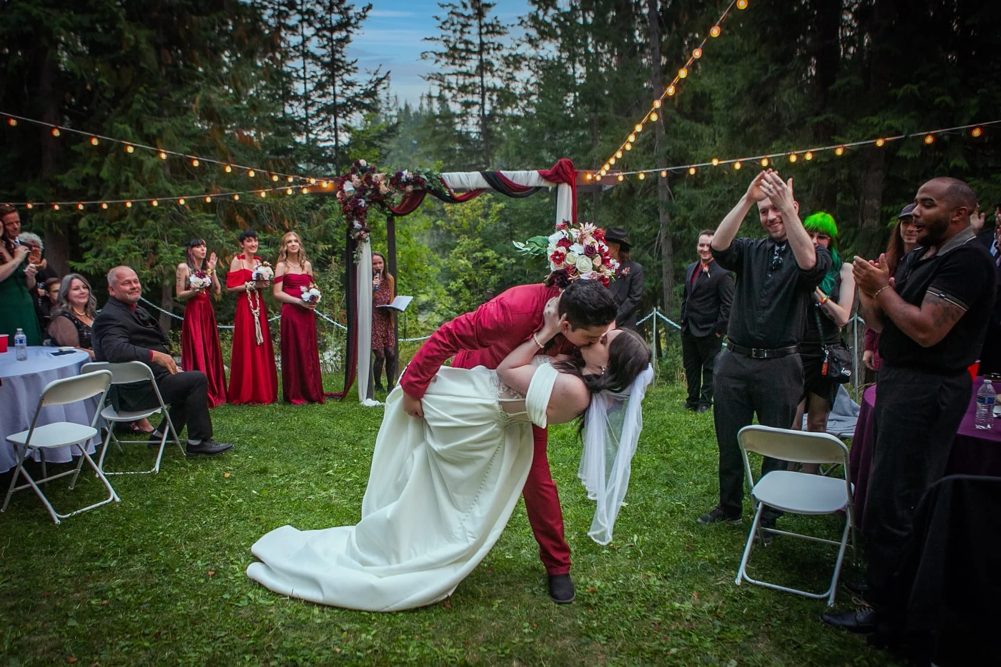 Fall wedding at dusk under the string lights dazzling the greenery of this funky bohemian wedding venue 
