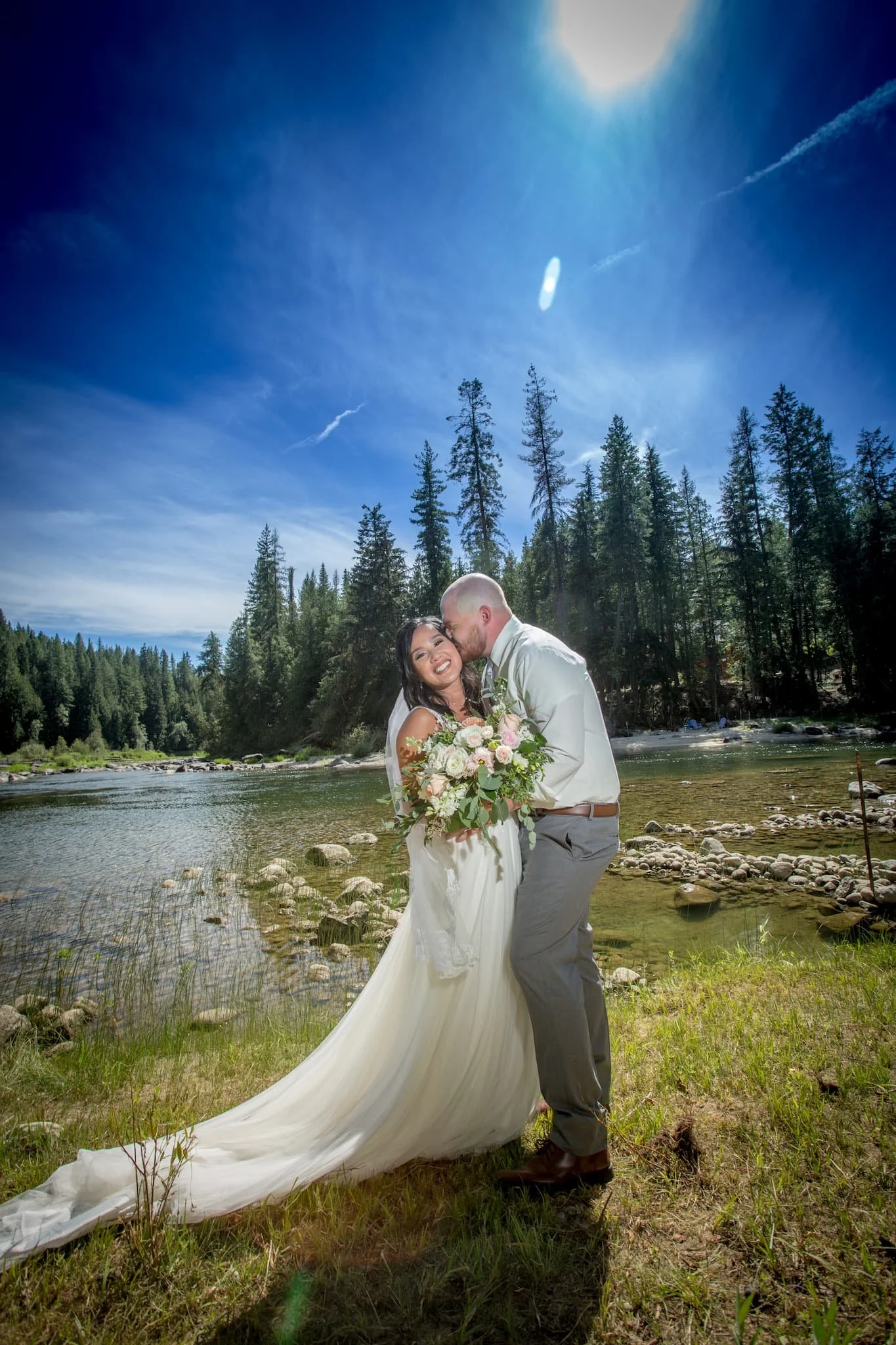 Couple sharing the first look before the wedding on the riverfront of Cedar River wedding venue close to Coeur d' Alene, Idaho