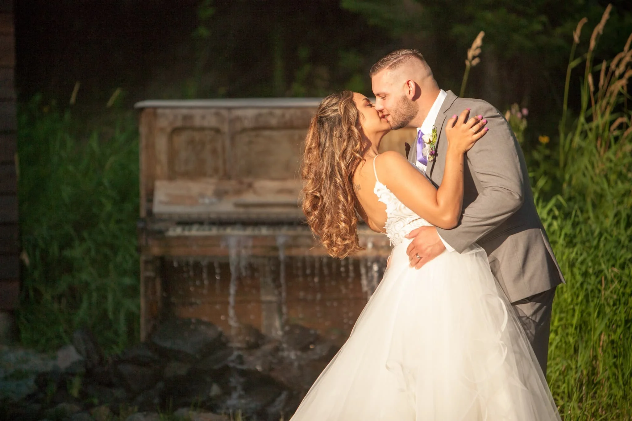 A bohemian-style wedding setup beneath the trees at our Northern Idaho riverfront venue, blending natural textures, soft light, and a relaxed, free-spirited atmosphere.