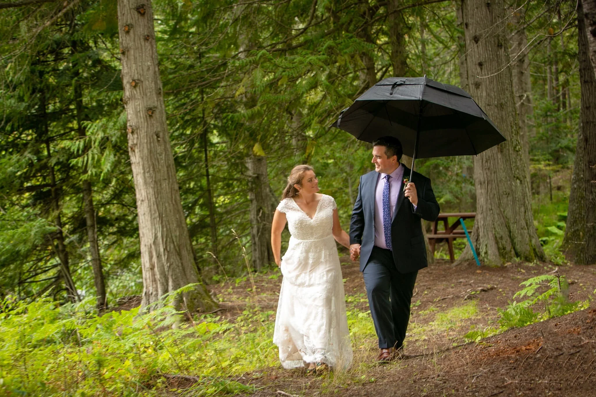A peaceful riverfront wedding ceremony in Priest River, Idaho, surrounded by towering pines and flowing water, ideal for intimate gatherings that feel grounded and personal.