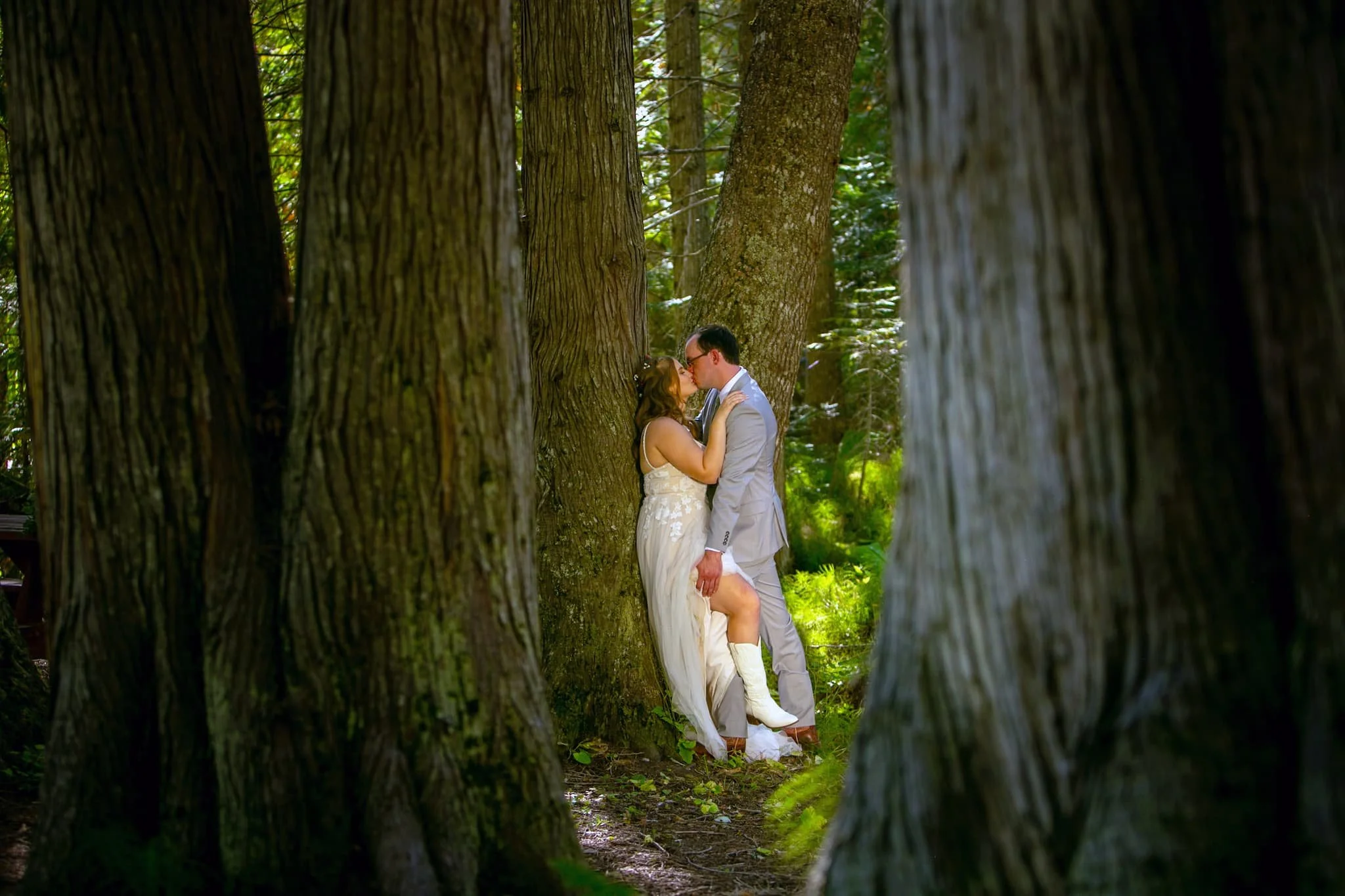 Intimate moment captured in the shady cedars of this wedding venue located near Priest Lake, Idaho