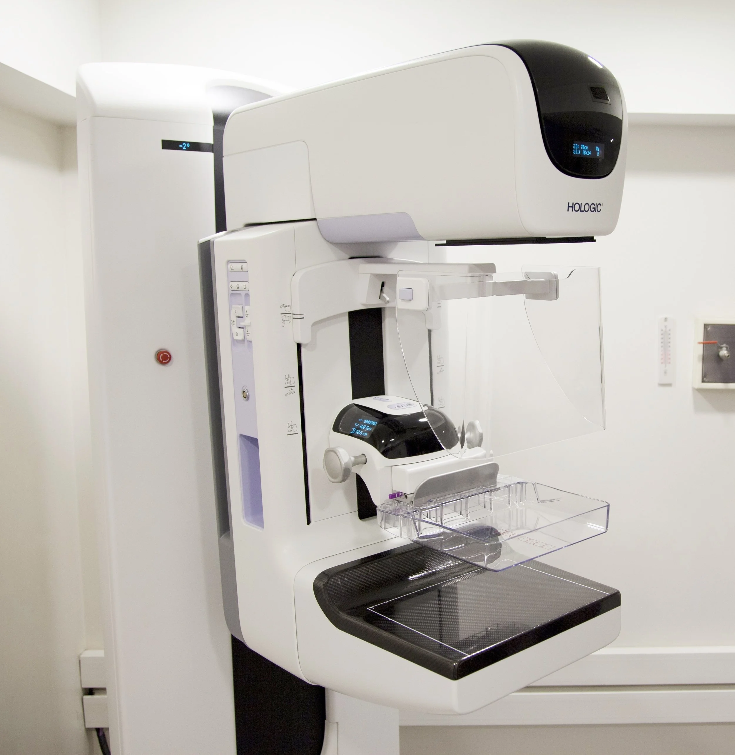A mammography machine in a medical room, used for breast imaging.