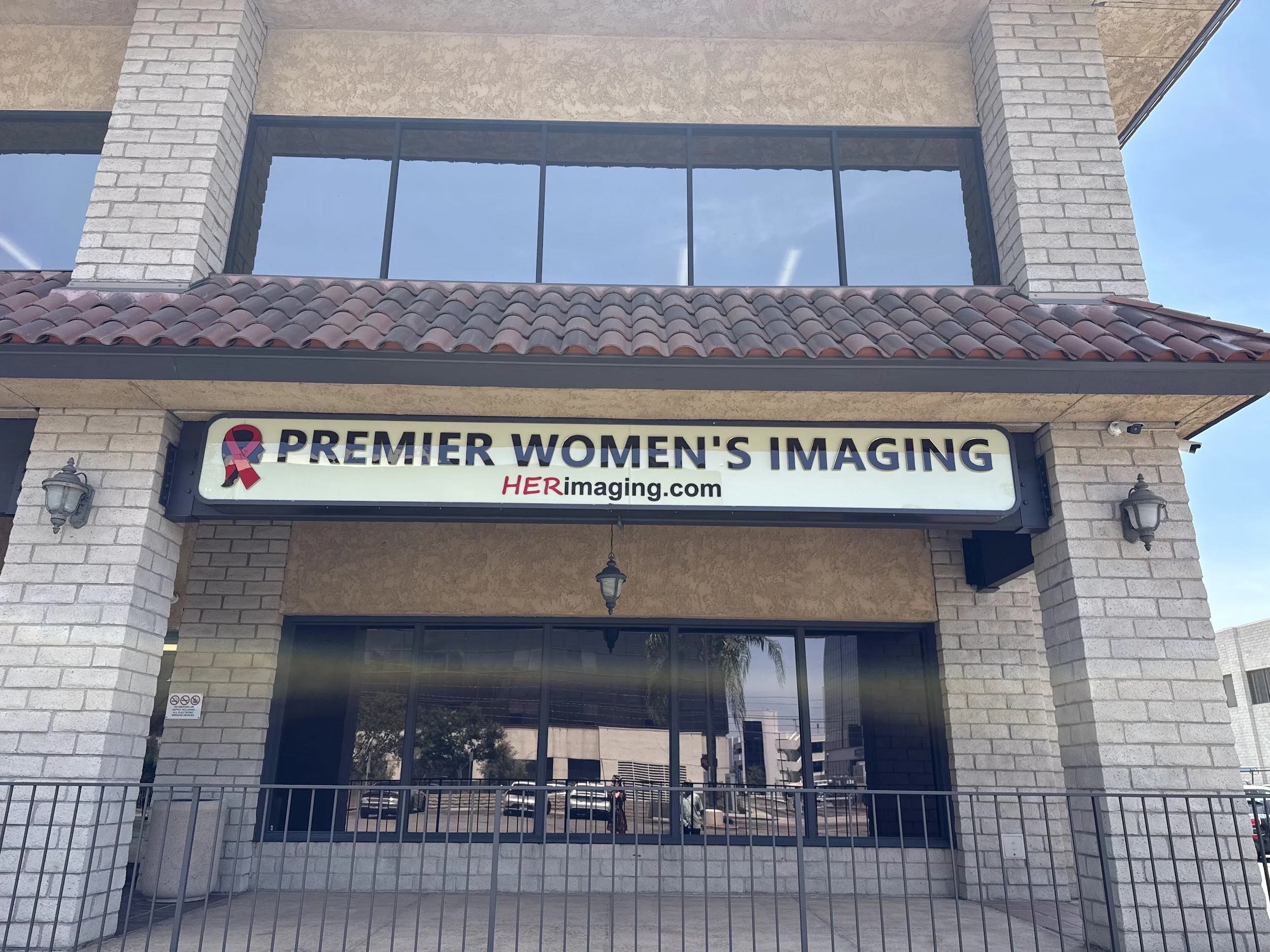 Building with a sign that reads "Premier Women's Imaging" and a pink ribbon symbol.