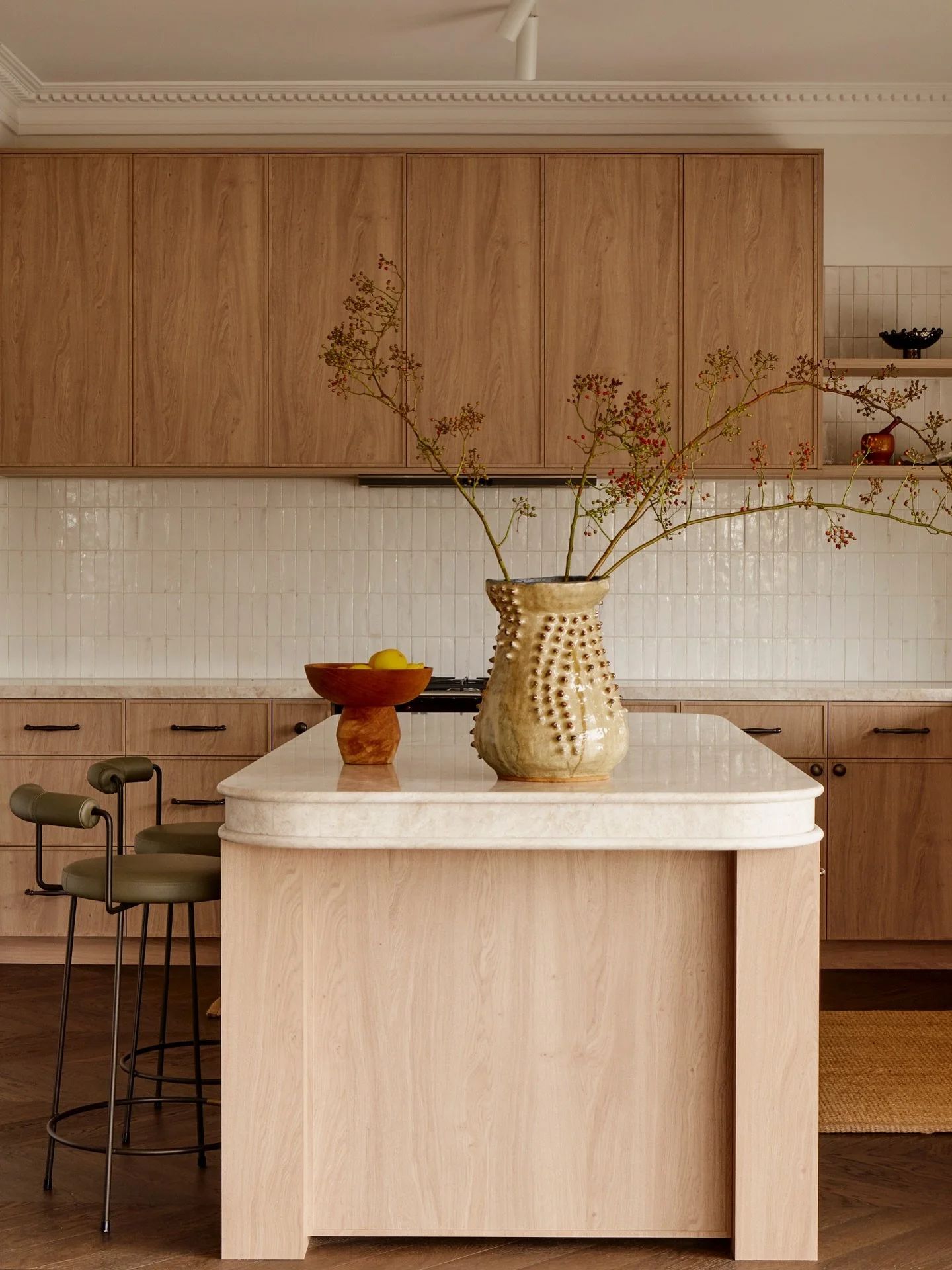 Curves invite, textures whisper. Stone meets timber, tile catches the light. Morning hums through the space &ndash; coffee brewing, chairs pulled close. A kitchen made for gathering, where warmth lingers and stories unfold.

Interior Design / Build /