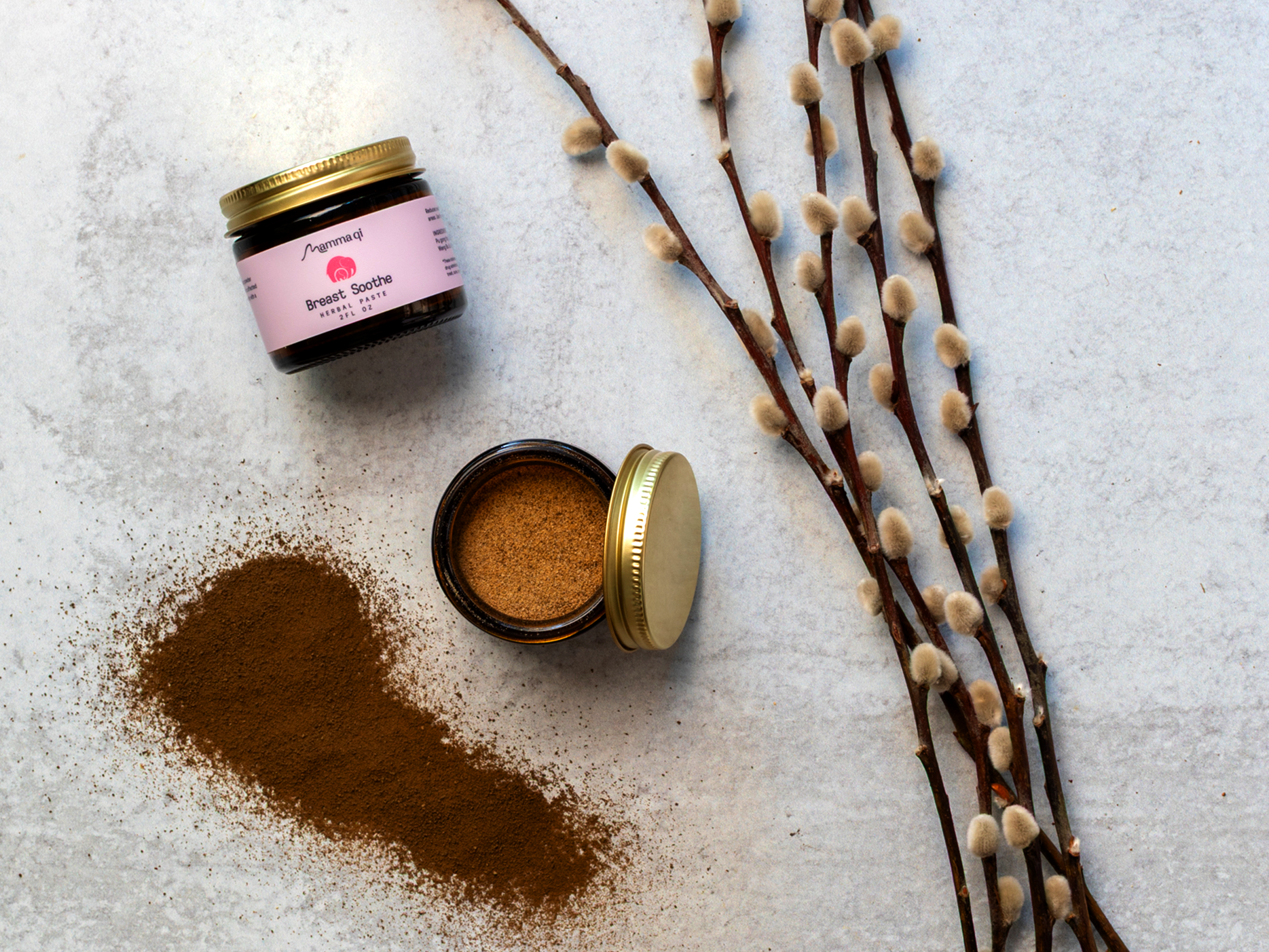 Breast Soothe powder on a table with herbs.png