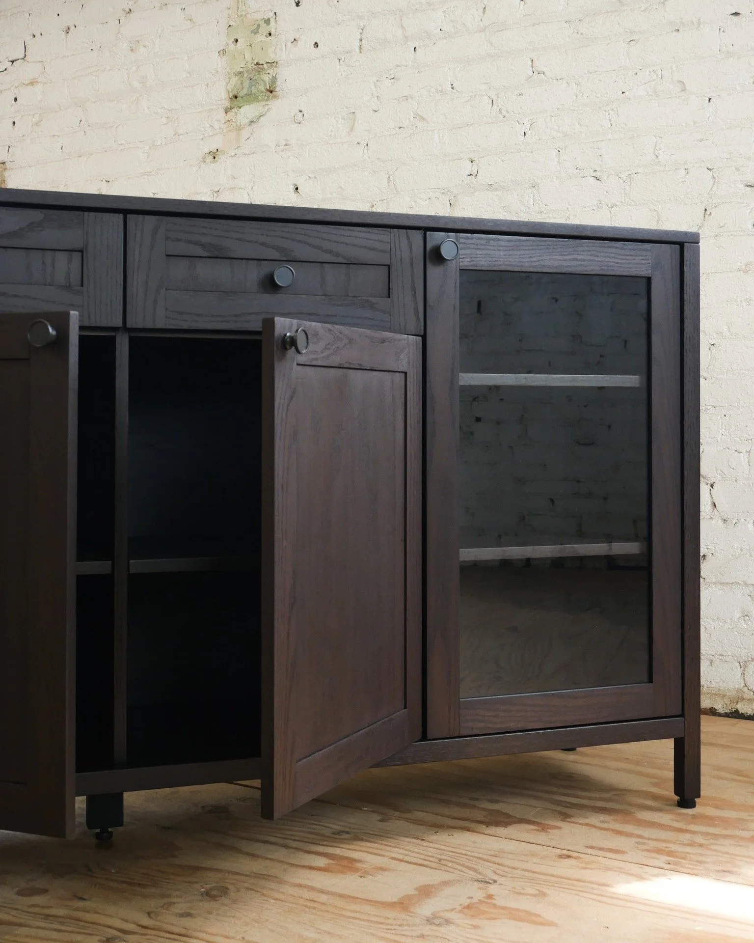 This custom piece we recently completed will display wine and stemware in a dining room through its framed-glass doors. 

#customfurniture #furnituredesign #finewoodworking