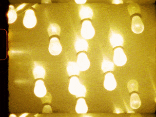 Multiple light bulbs hanging in a string, lit and glowing