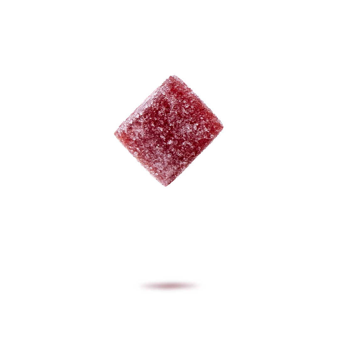 A frozen red gummy candy with sugar crystals, floating above a shadowed surface on a white background.
