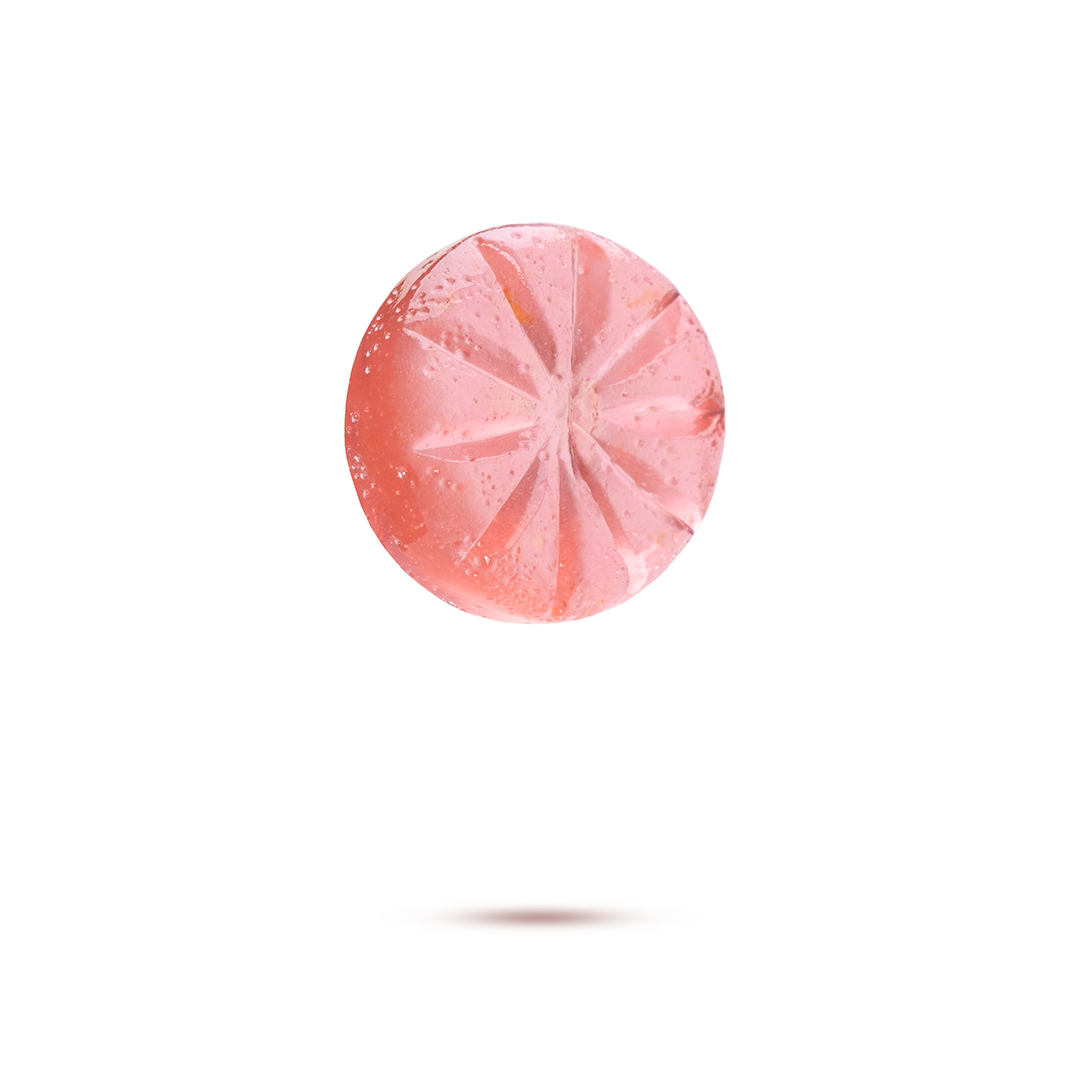 Pink citrus fruit, possibly a grapefruit, floating above a white background with a shadow underneath.