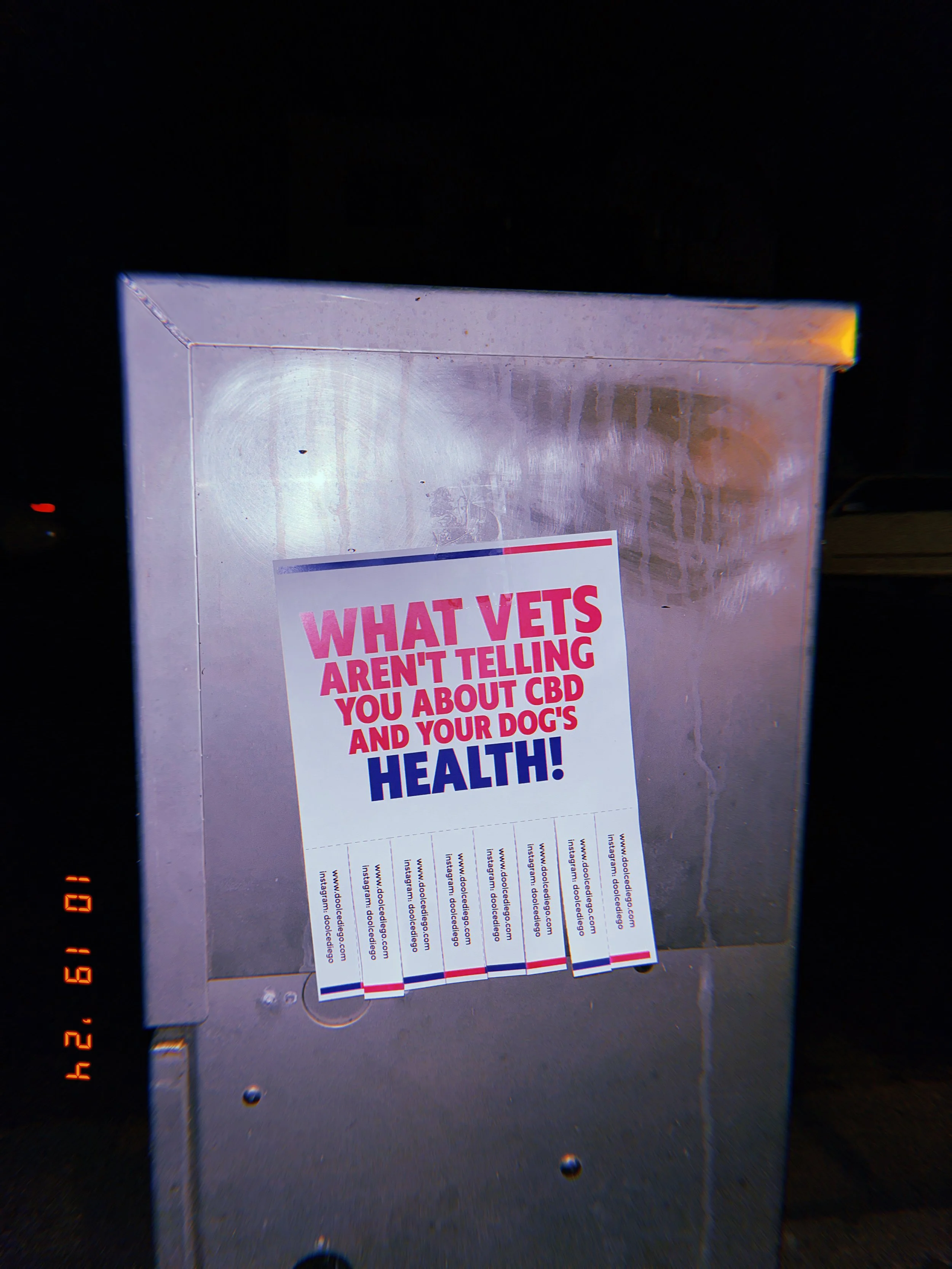 Signboard with a message about vets and CBD, placed inside a metallic frame.